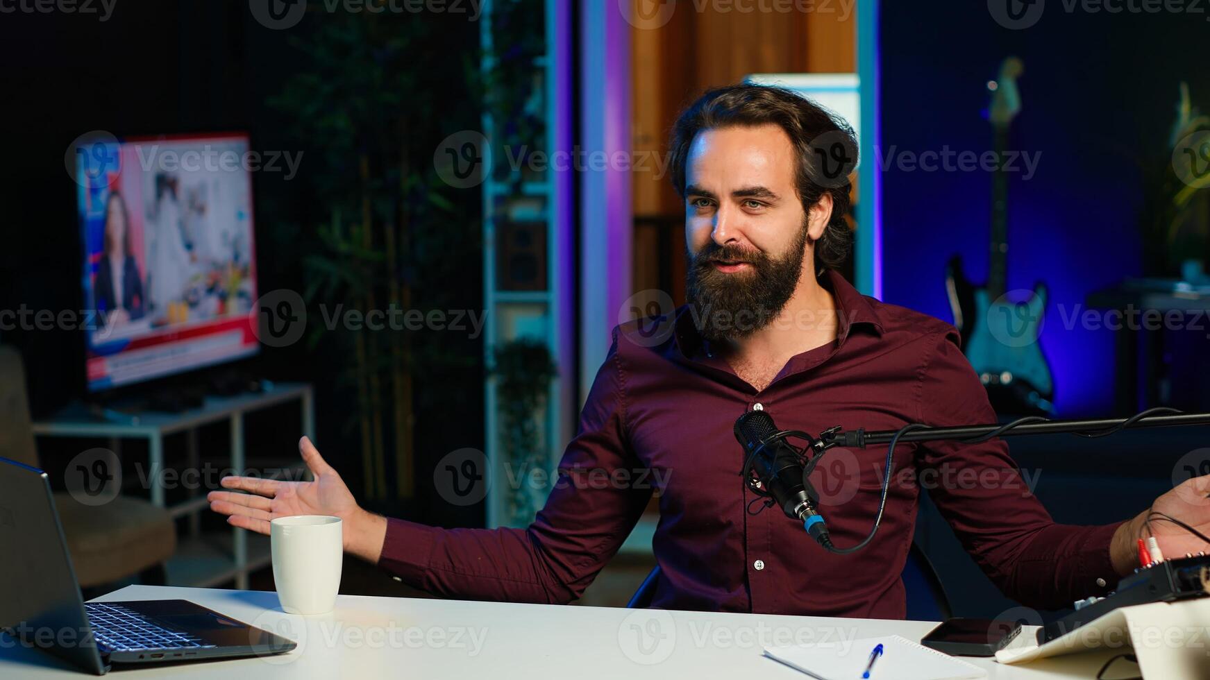 Playful online star using tech equipment to shoot , doing frantic gesturing. Energetic content creator jumping on chair, having fun while filming vlog with professional mic in studio, camera A photo