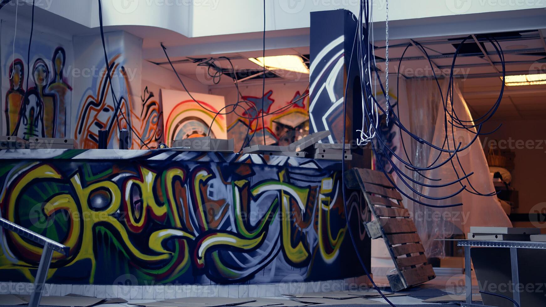 Empty abandoned warehouse with graffiti paintings on walls, concept of alternative lifestyle. City slums ghetto location used as crime haven by anti establishment protestors doing street art photo
