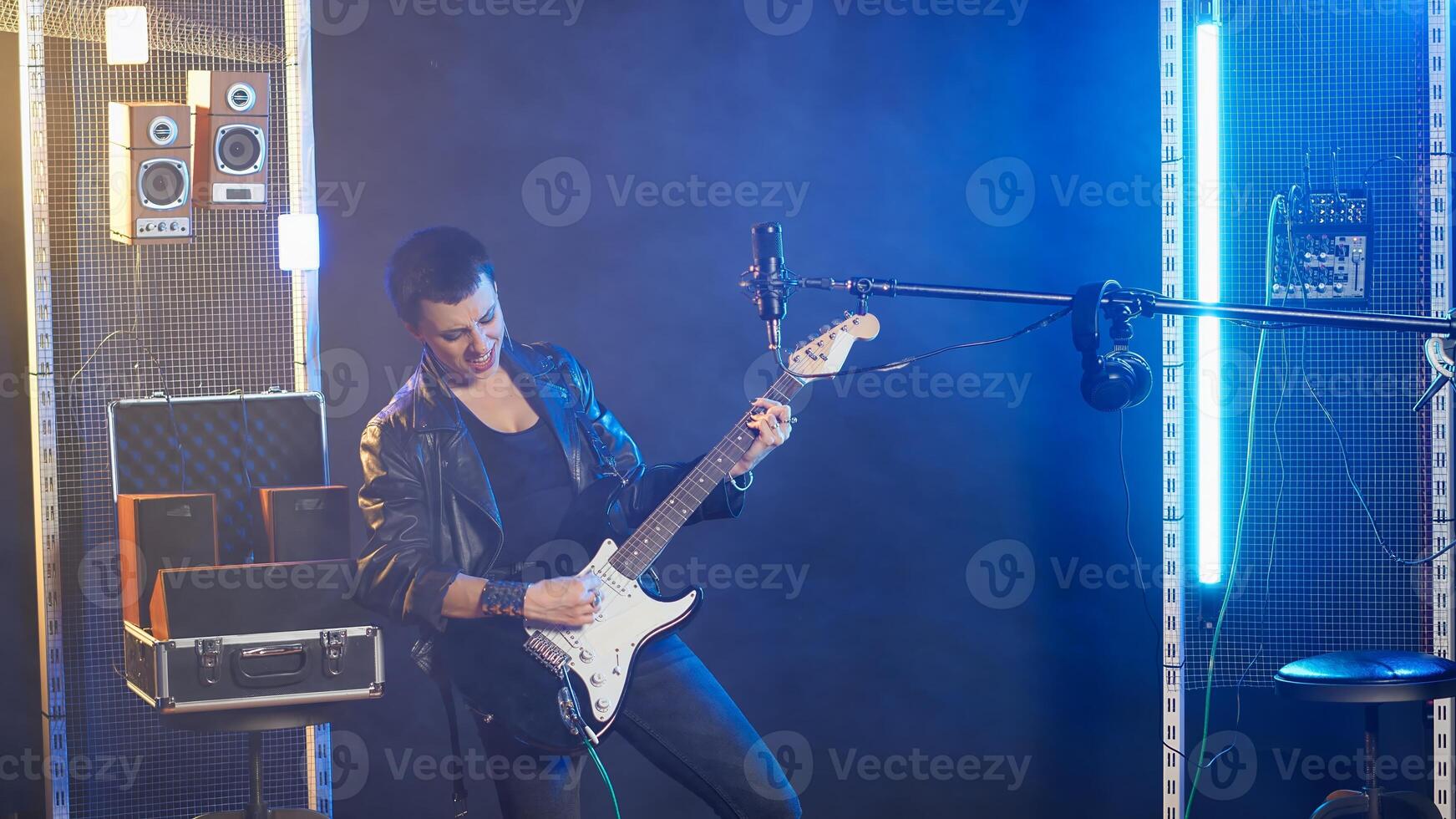 Woman rocker performing on electric guitar in a live show, delivering a powerful and energetic musical performance. Artist musician with an edgy style and rebellious grunge vibe. Camera B. photo