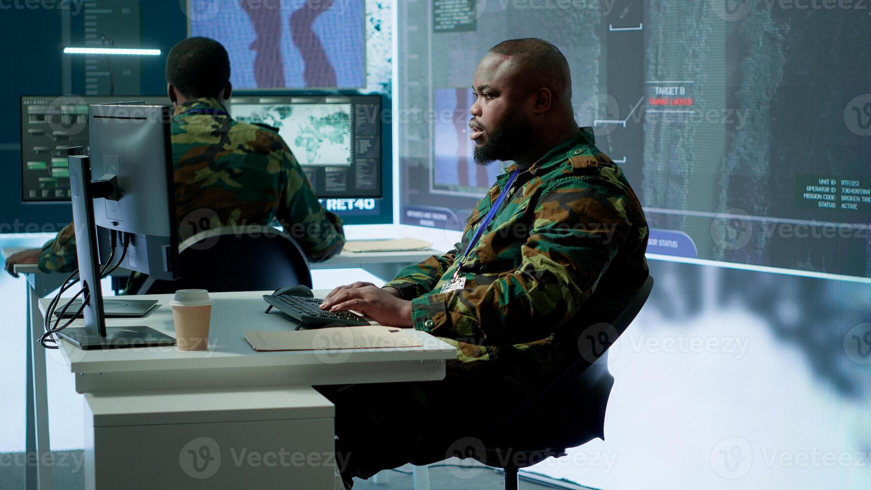 Army intelligence specialists using advanced computer systems and satellite data to enhance national security, critical information. Soldiers planning for mission in high tech control room. Camera A. photo