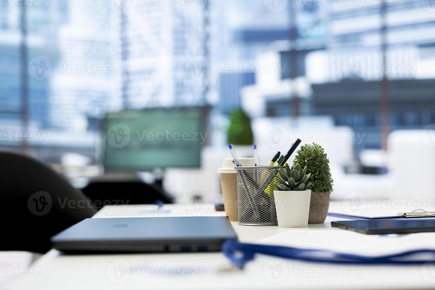 Focus on laptop in empty company financial department with stock portfolio on computer in blurry background. Close up on notebook in workspace with live index indices on PC screen photo