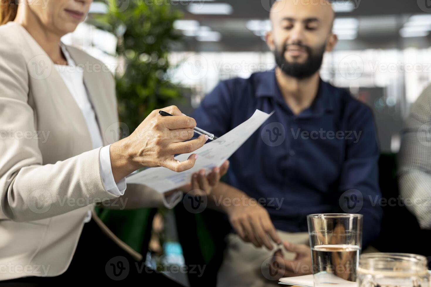 Company CEO attends meeting to discuss about new business vision with executive board presenting him business growth ideas. Close up of employee pitching investment strategy to manager photo