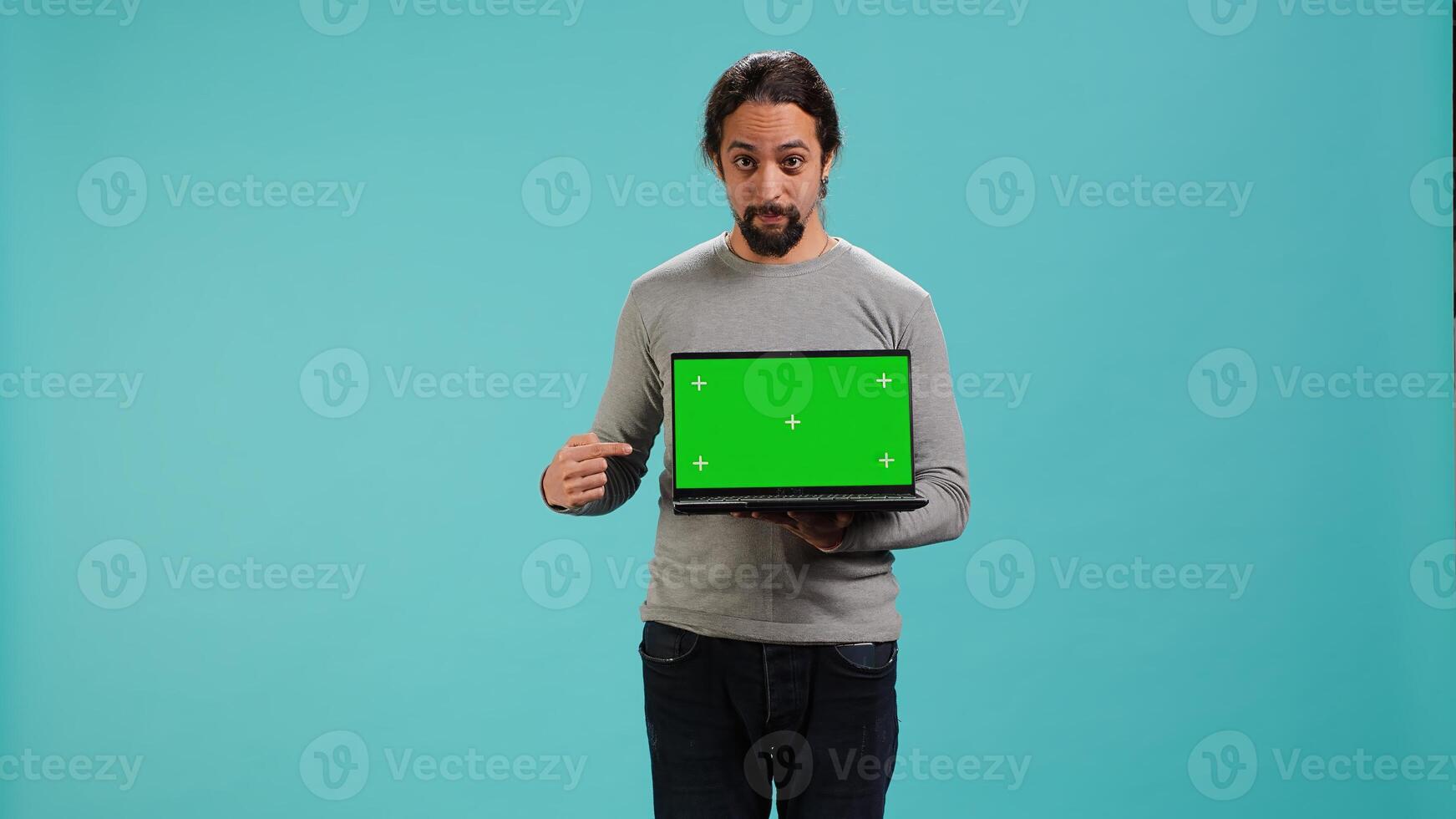 Portrait of worker holding isolated screen laptop, doing important work for company, studio background. Employee with chroma key device at work solving job tasks, camera A photo