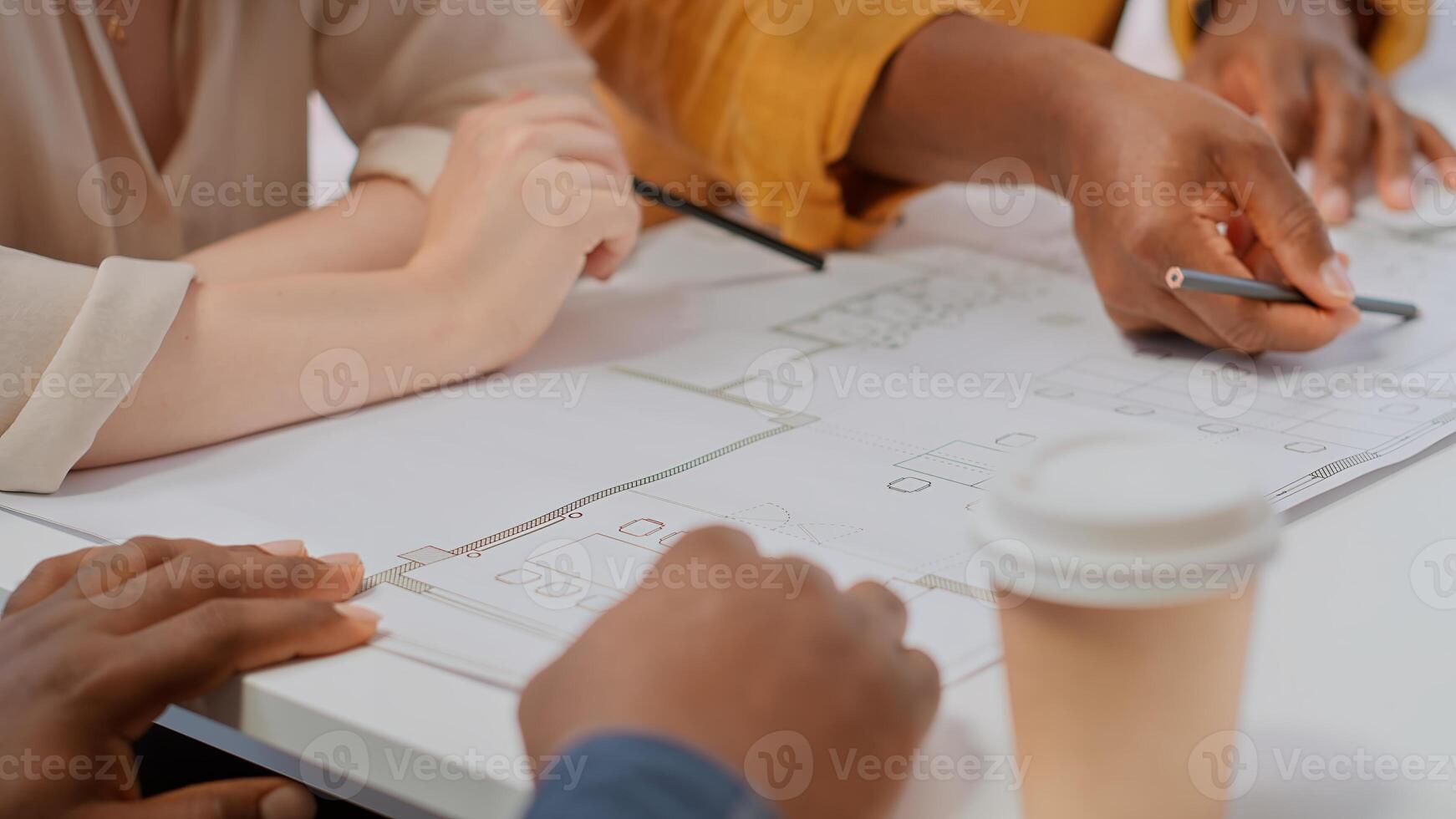 Brokers team and entrepreneur discussing a real estate potential, evaluating architectural plans and negotiating contract terms for renting a high class office space. Rental agreement at desk. Camera B. photo