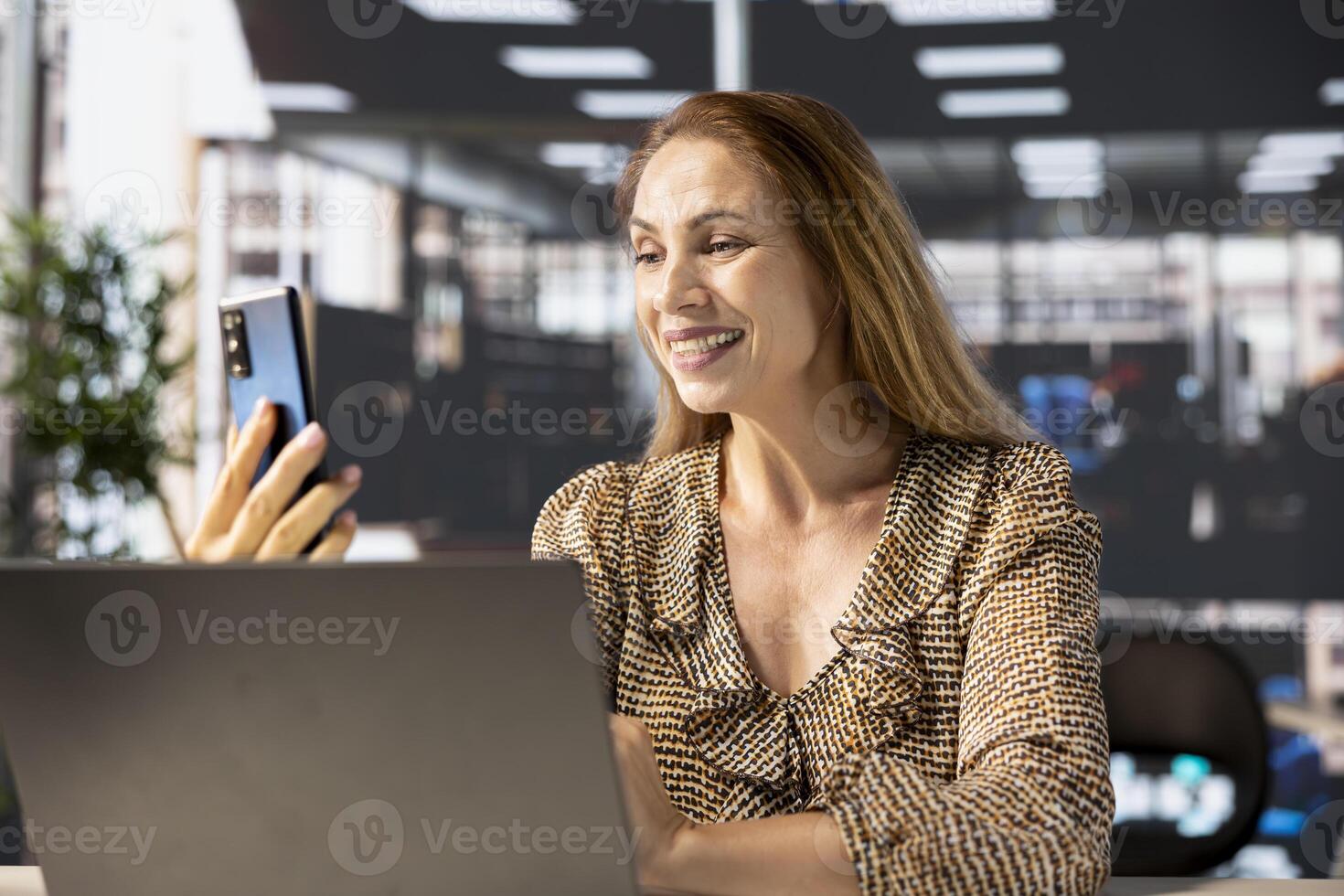 Professional businesswoman joins a digital meeting to discuss enterprise solutions and project goals. Attending a telecommuting session with shareholders for organizational development. photo