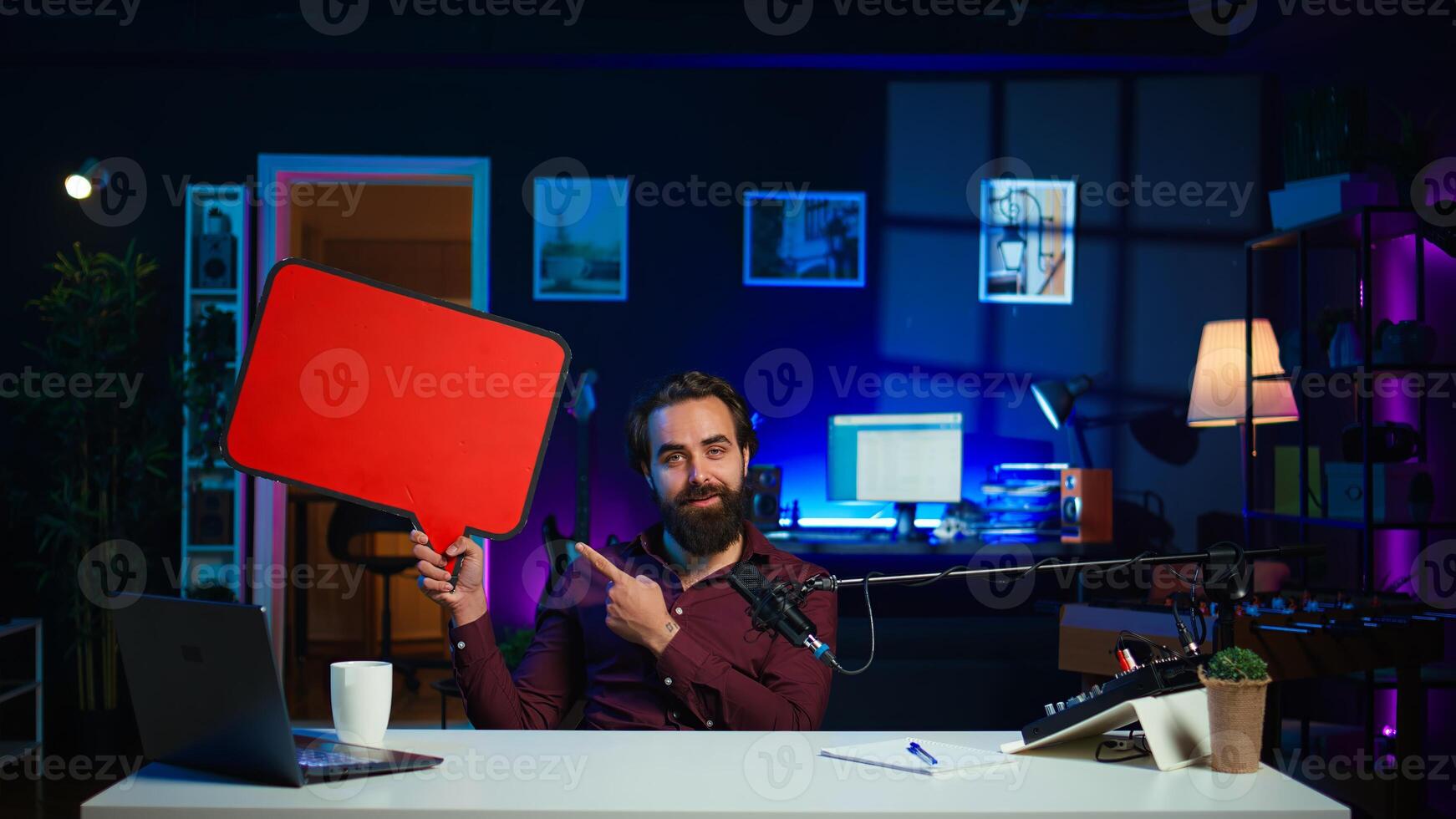 Man arriving in studio, filming sponsored content, holding empty copy space sign, following script, talking to audience. Internet star using cardboard bubble speech cutout to do marketing, camera B photo