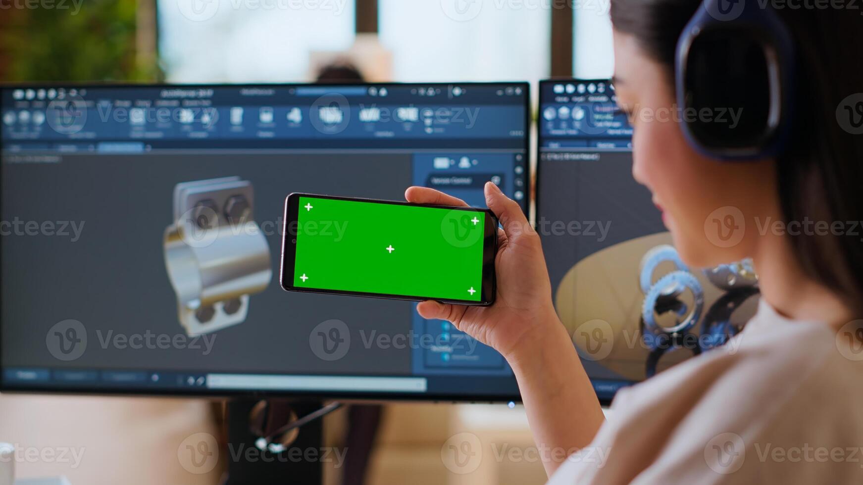 Software developer works in a modern office with green screen and dual monitors. Home workspace emphasizes industrial innovation and expertise in manufacturing design. Camera B. photo
