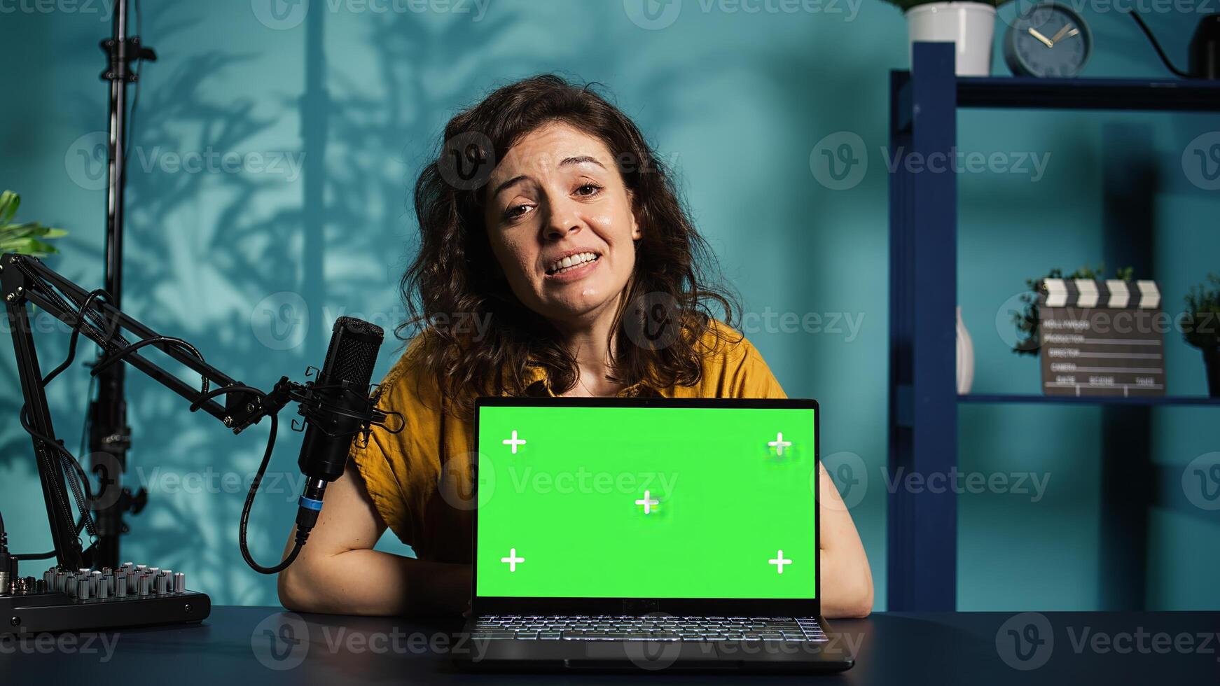 Online show host being sponsored by partnering brand to do isolated screen laptop unboxing content. Tech expert does influencer marketing, doing chroma key notebook product placement, camera B photo