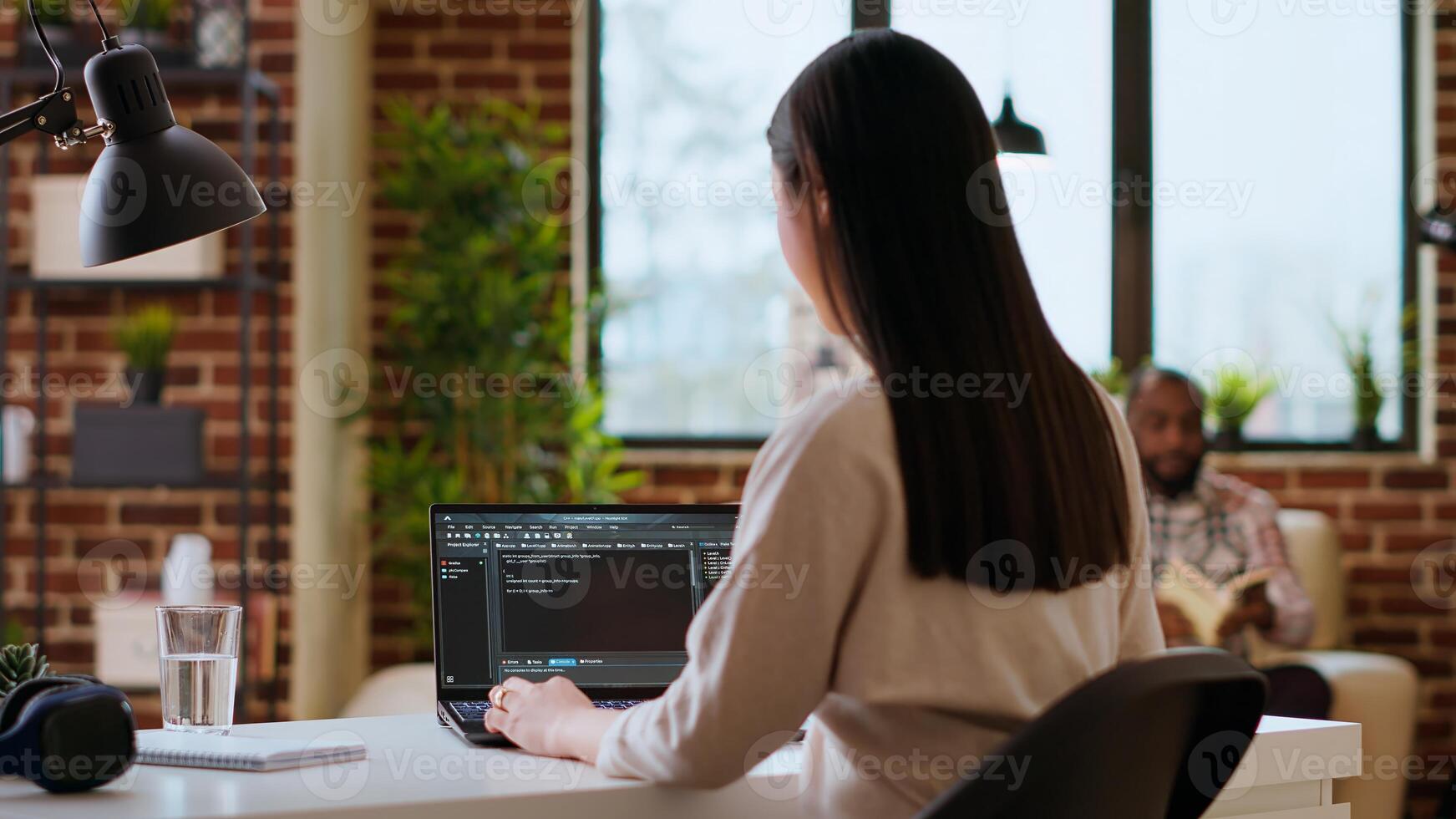 Professional asian software engineer is working remotely typing code on a laptop, using programming language. Woman works on cloud computing, software projects in a digital environment. Camera B. photo