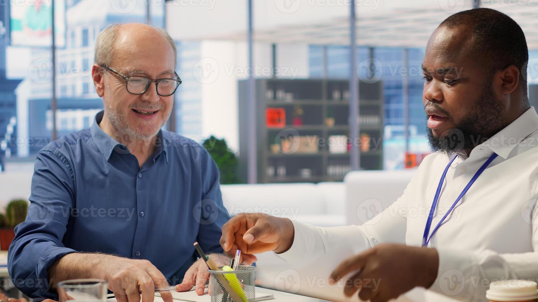 Financial adviser explaining retirement and pension options to old couple, potential contract terms to secure investment with life savings. Broker offers counseling for senior people. Camera A. photo