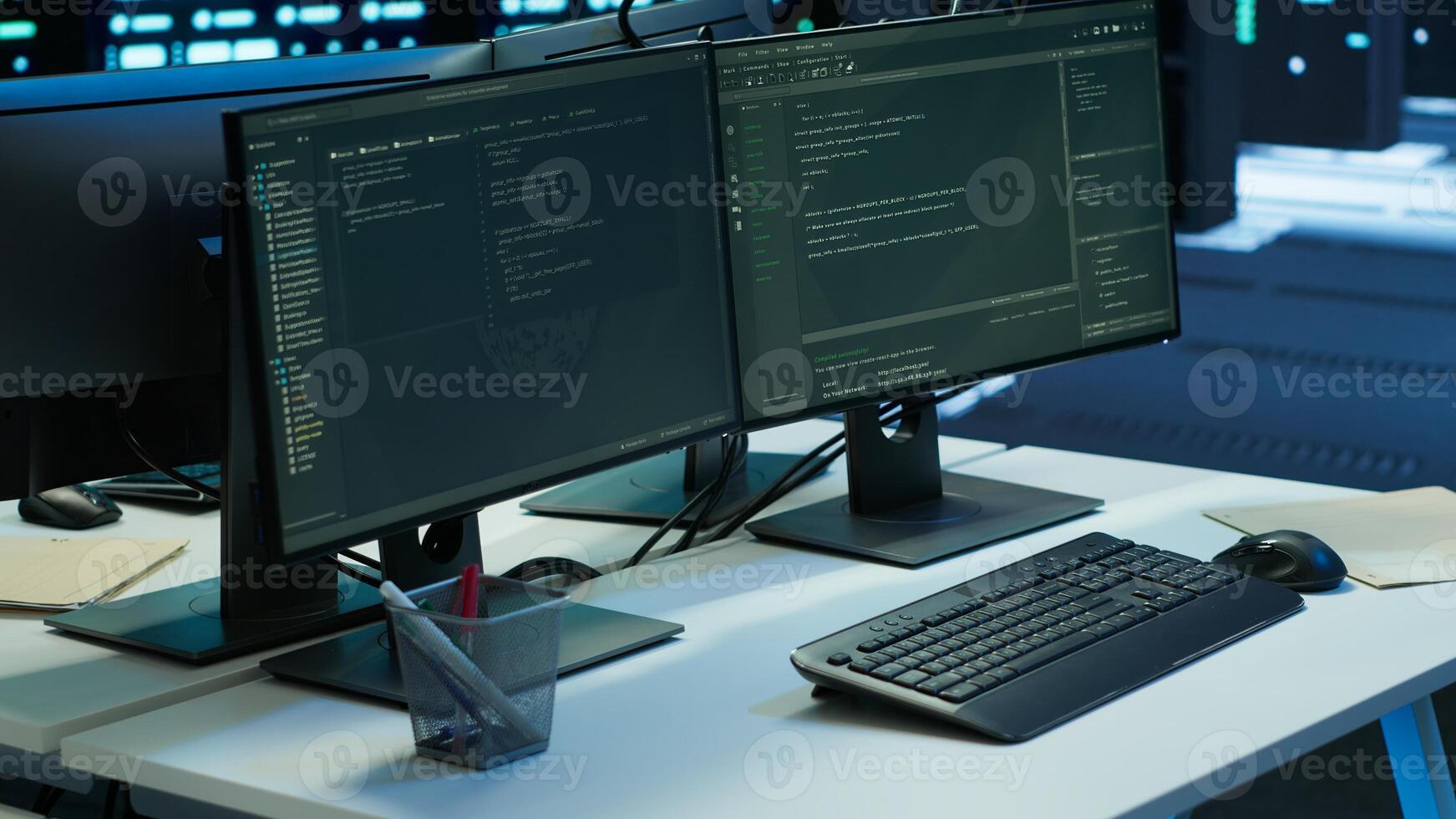 Data center workplace with networking systems installed used for managing infrastructure racks. Computer screens on desk in advanced server hub used for overseeing equipment photo