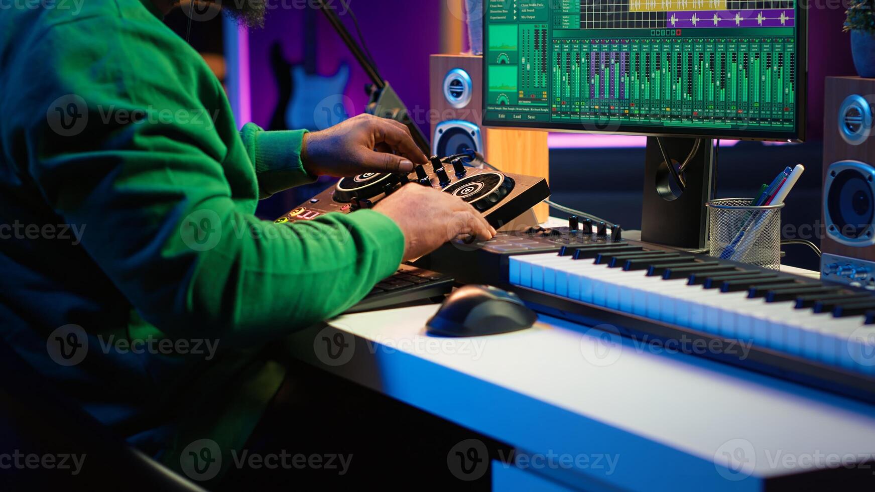 Skilled music producer composing new soundtracks on console and daw software, working with stereo gear in home studio. Young artist engineer uses pre amp knobs, signal processing. Camera A. photo