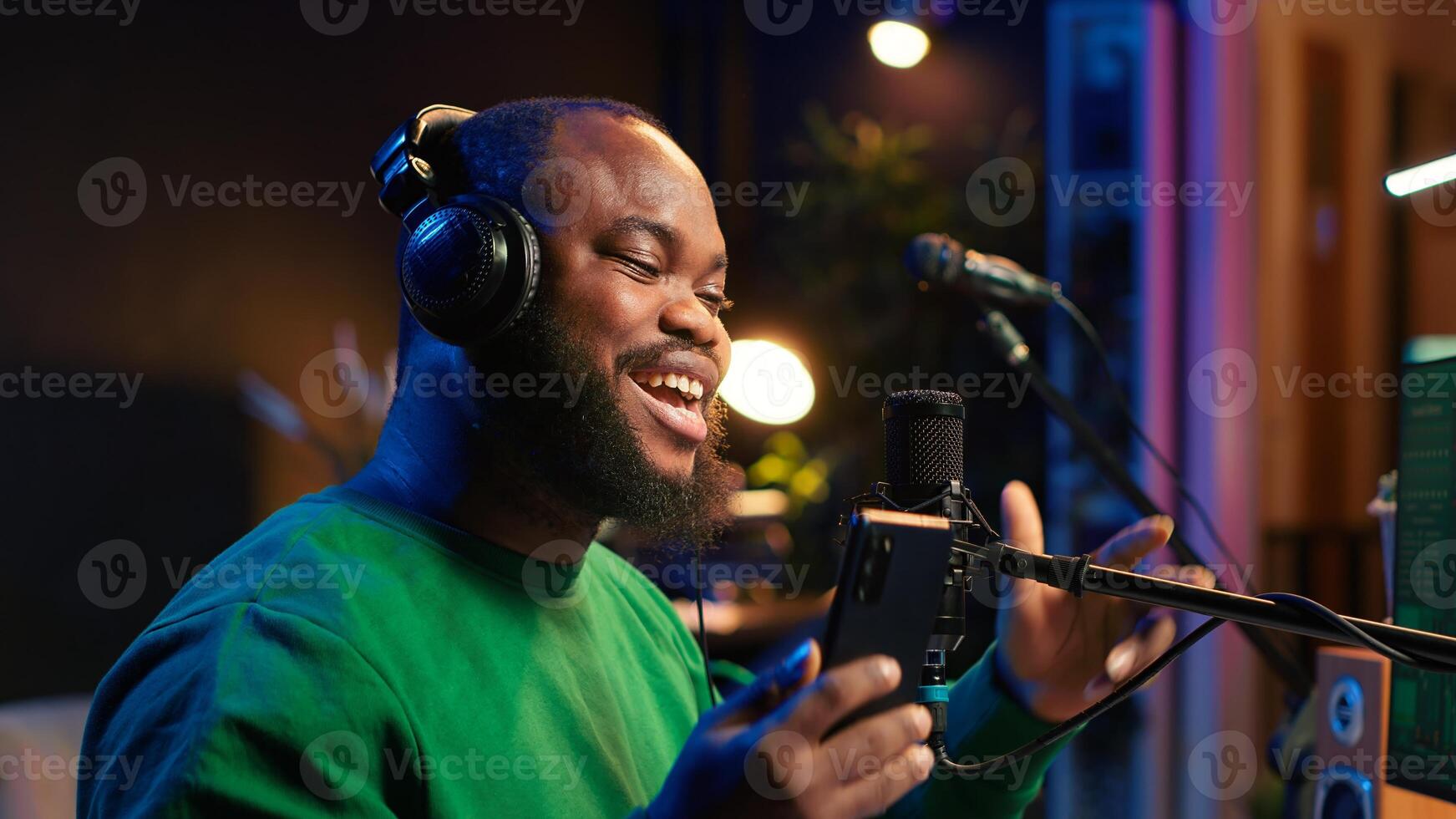 Songwriter singing new song on his microphone to produce new tracks for music industry, home studio gear. Artist records voice and lyrics to edit in mixing and mastering session. Close up. Camera A. photo