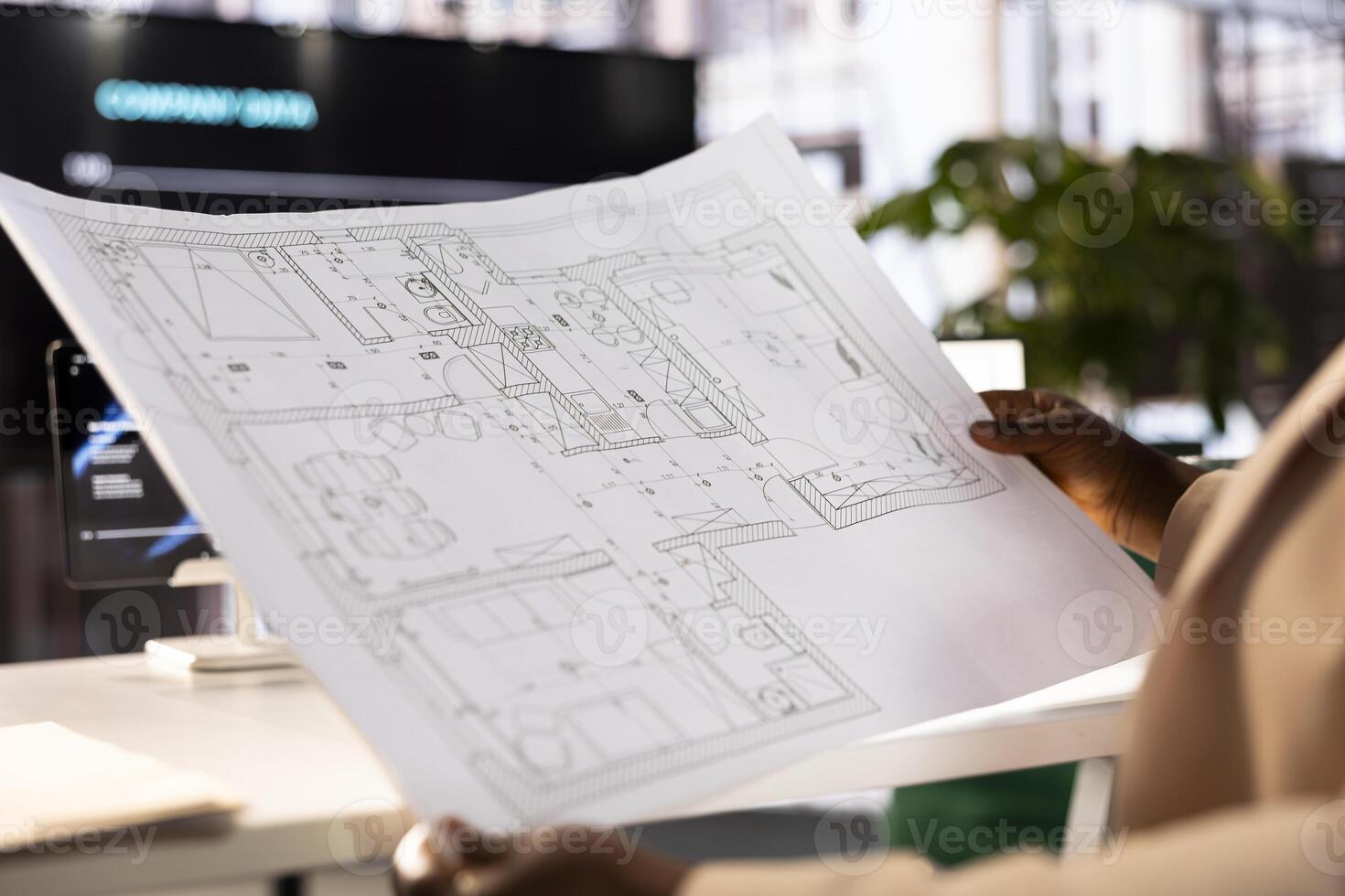 Architect preparing detailed drawings showing interior structure of building project. Close up of freelancing architecture professional in office designing house infrastructure photo