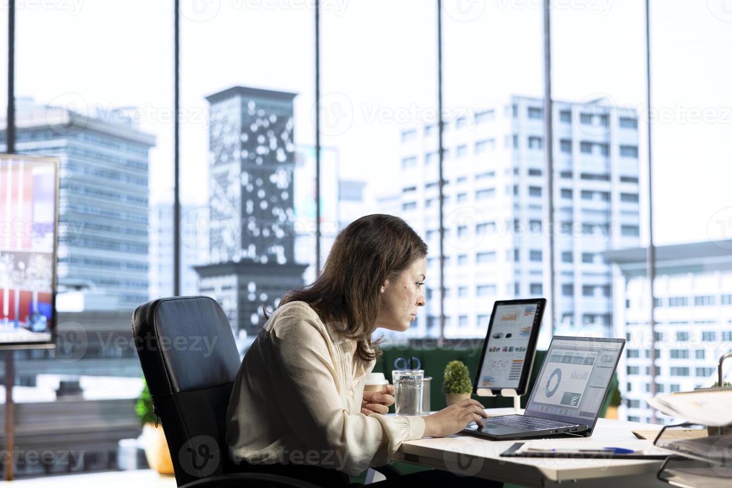 Ambitious woman executive ensuring corporate innovation, exploring new technologies and business models to enhance the company competitive advantage. Evaluating results and analytics. photo