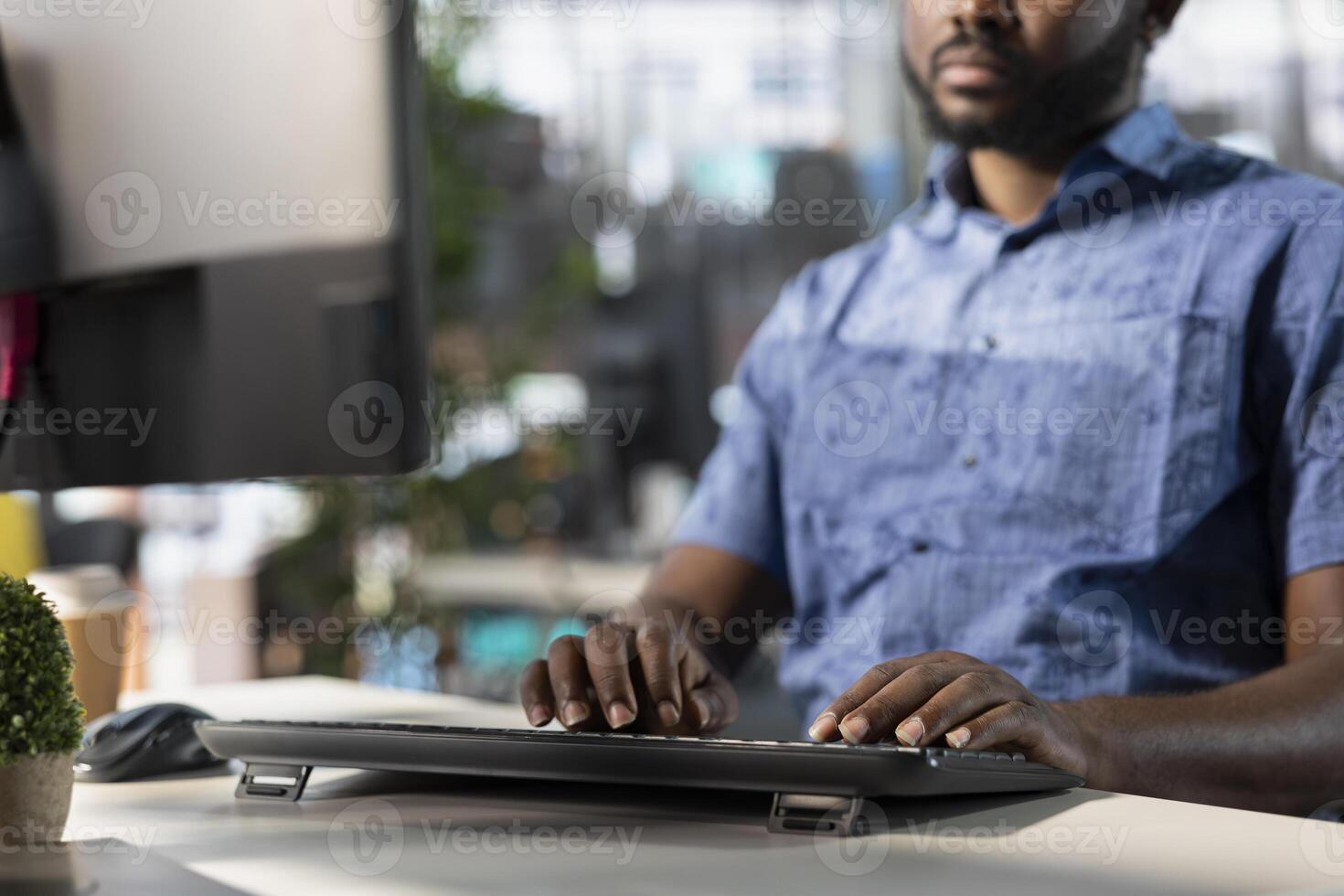 Data scientist typing on keyboard, creating machine learning models that can process and analyze data to improve and automate decision making processes. Close up of man programming in office using PC photo
