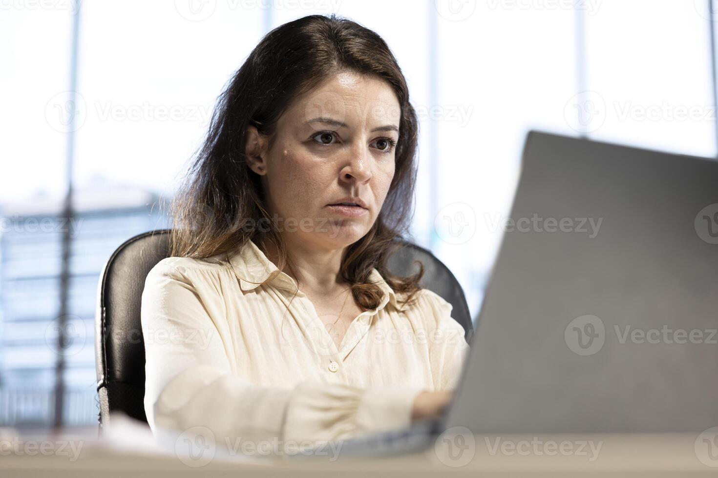 Determined female CEO analyzes financial reports and develops a growth strategy to increase income, showcasing determination and decision making. Inspirational women empowerment. photo