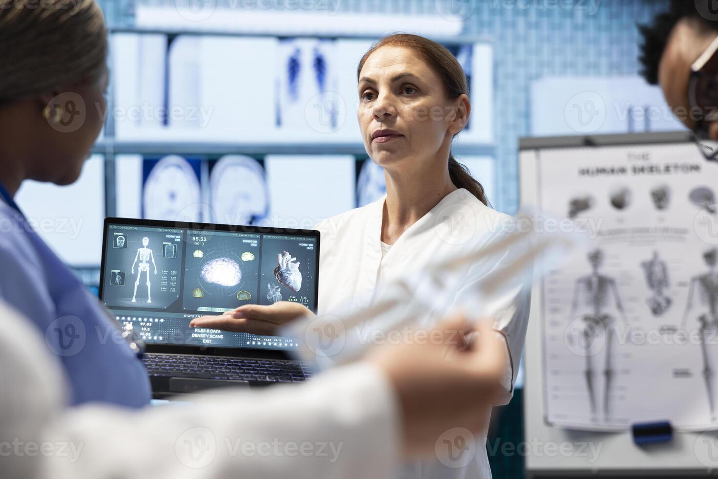 Radiologists doctors analyzing cardiology scans to detect heart conditions, developing effective treatment strategy. Working on electrocardiogram test results, healthcare industry. photo