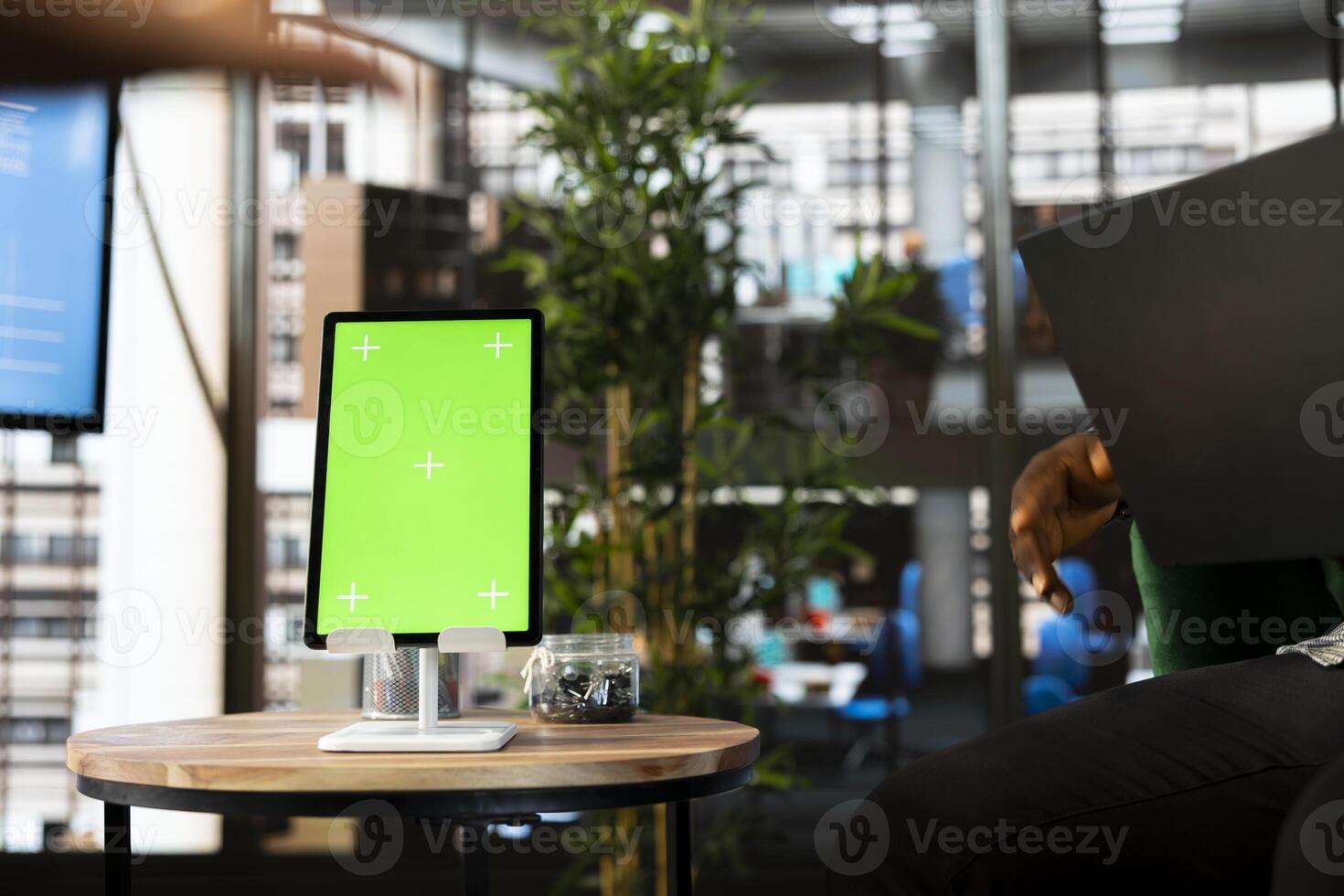 Team of workers in office maintaining relationship with business partners, looking at metrics on green screen tablet. Teamworking colleagues showing shareholders data on mockup device photo