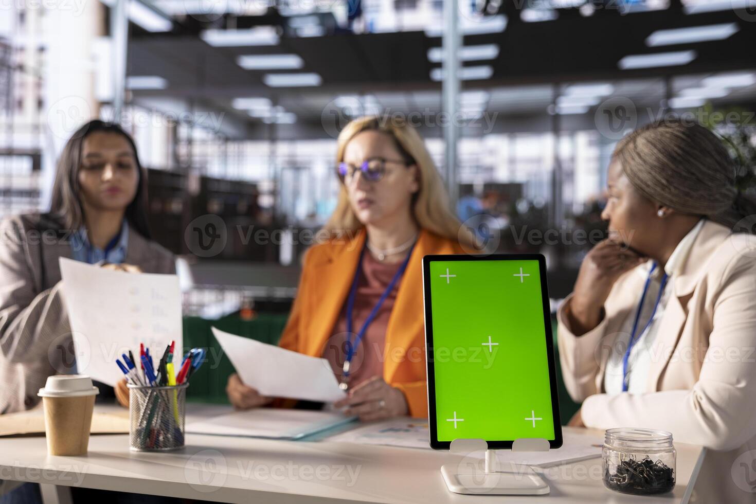 Entrepreneurs team with a success story work next to green screen, using professional devices and tools to meet project deadline and obtain business growth. Leadership skills and professionalism. photo