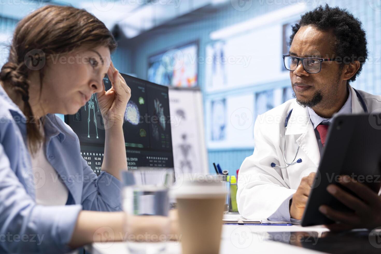 General practitioner giving the right diagnosis to woman patient, attending a checkup consultation in medical cabinet. Doctor explaining x ray imaging and scan results, care management. photo