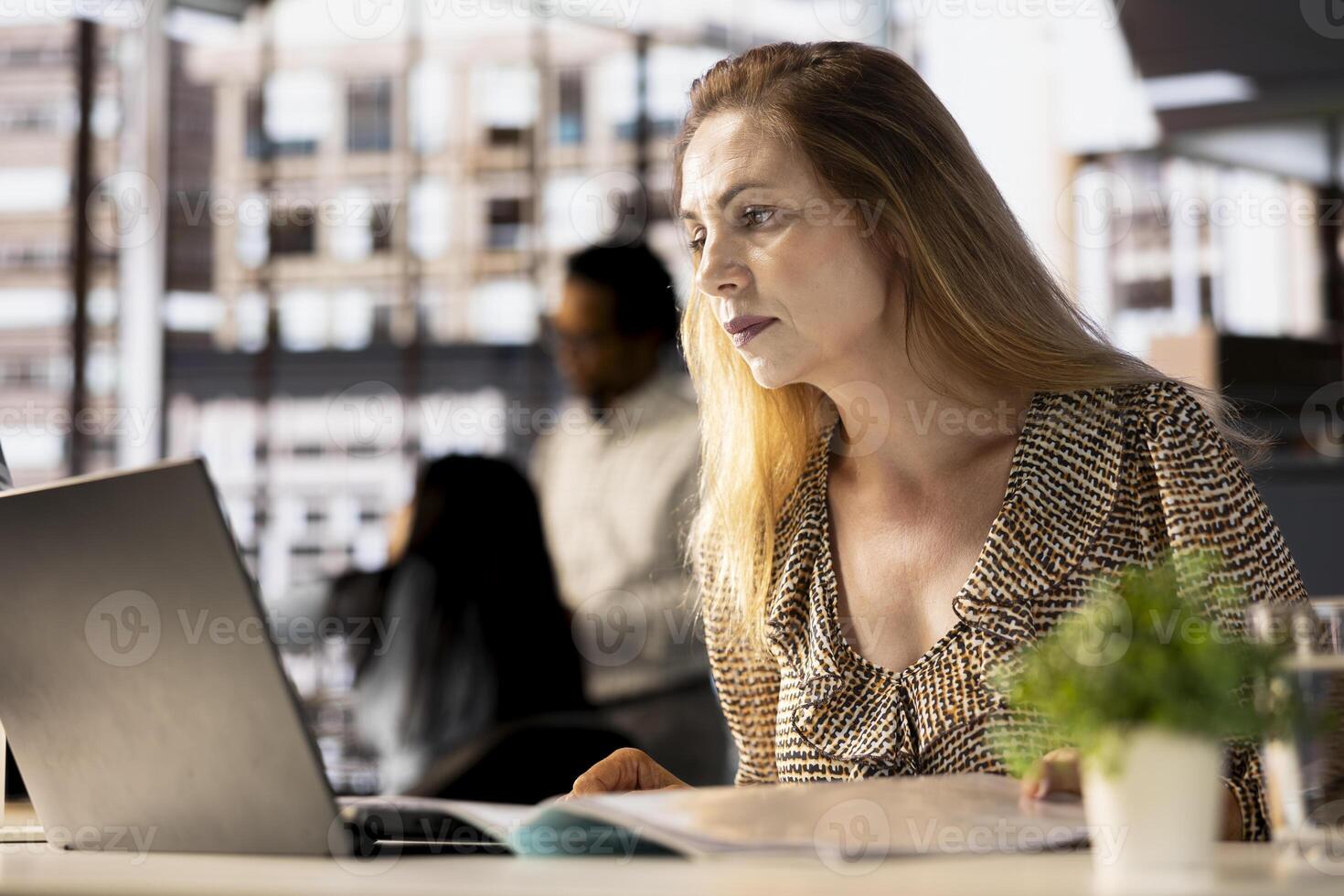 Female CEO engaging in project management using tech tools to set goals and objectives, solve problems and track the performance metrics of the company. Administrative tasks and decisions. photo
