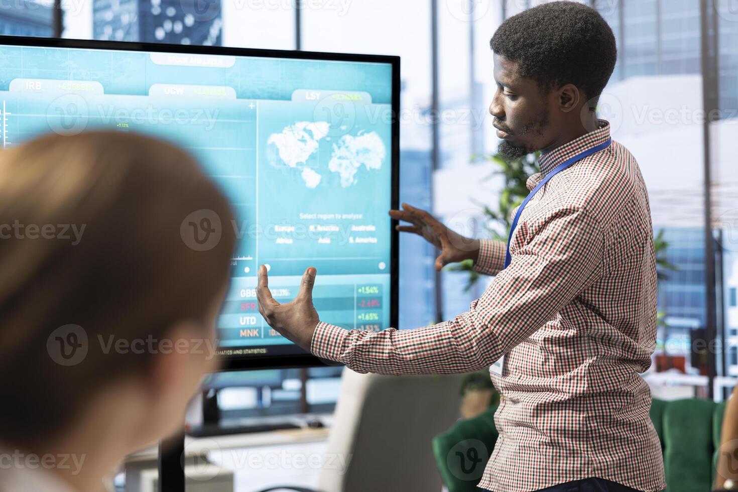 General manager making a presentation with infographics and sales numbers on interactive board, showing the organizational progress to the staff. Employees reviewing analytics plans. photo