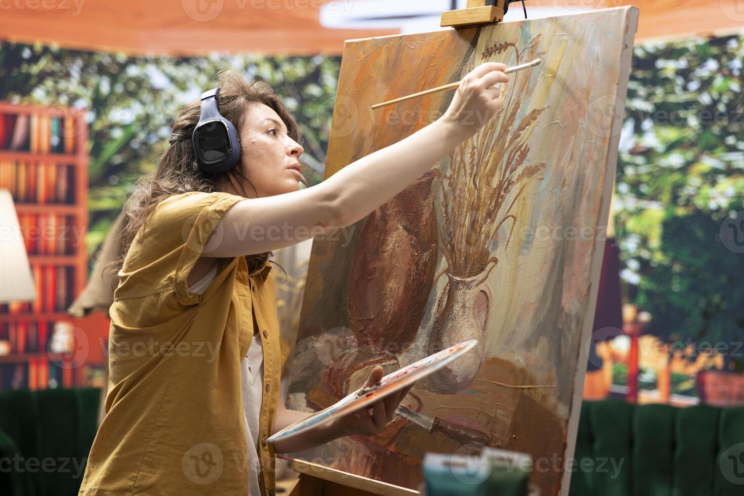 Artist in a gallery atelier works on a new colorful masterpiece, blending acrylic paints with precision. Creating a contemporary design and multicolored artwork as leisure activity. photo