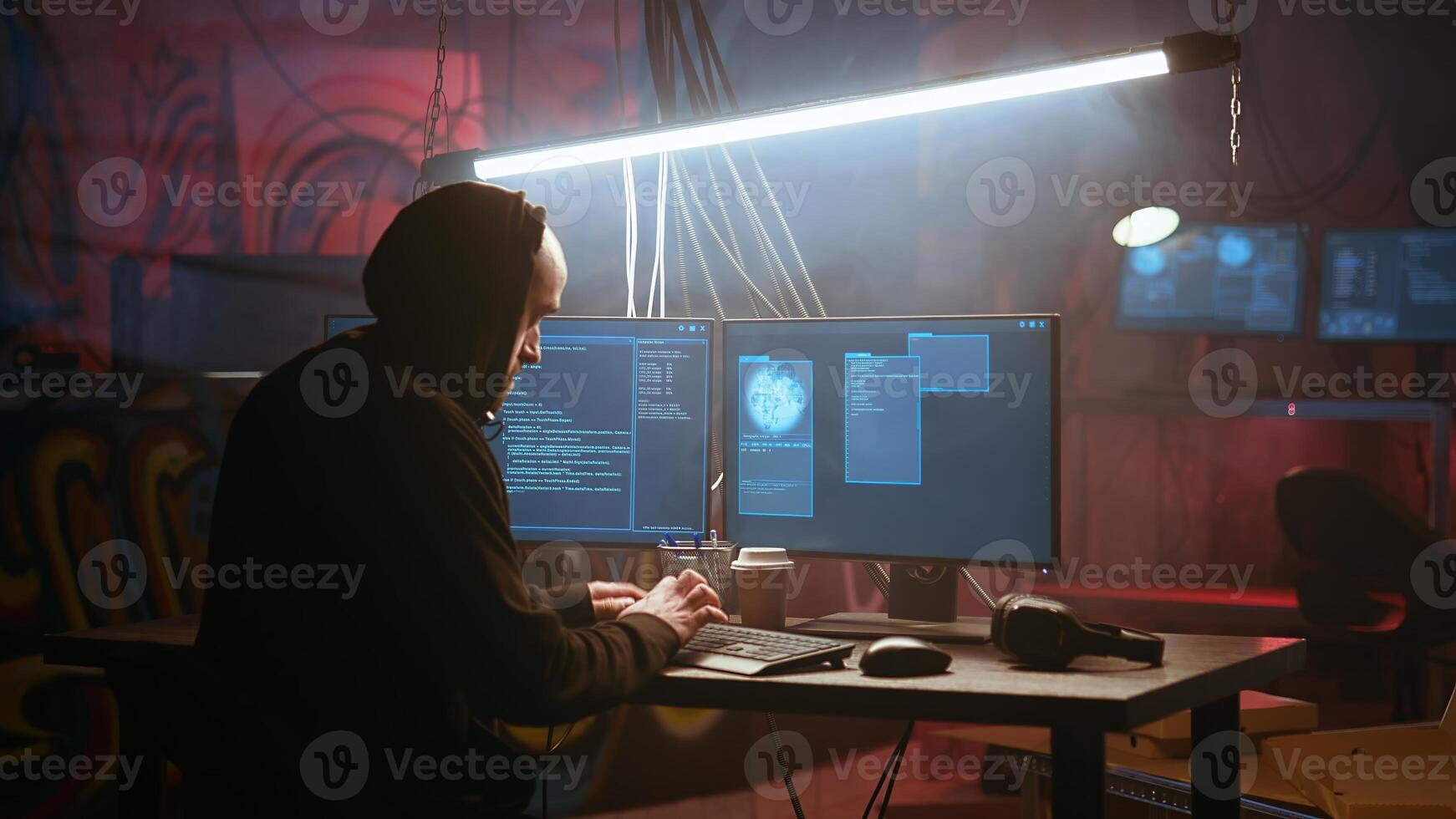 Hacker using high tech computer system to run malicious code in foggy dark basement. Rogue programmer committing illegal activities using PC in neon illuminated criminal hideout, camera A photo