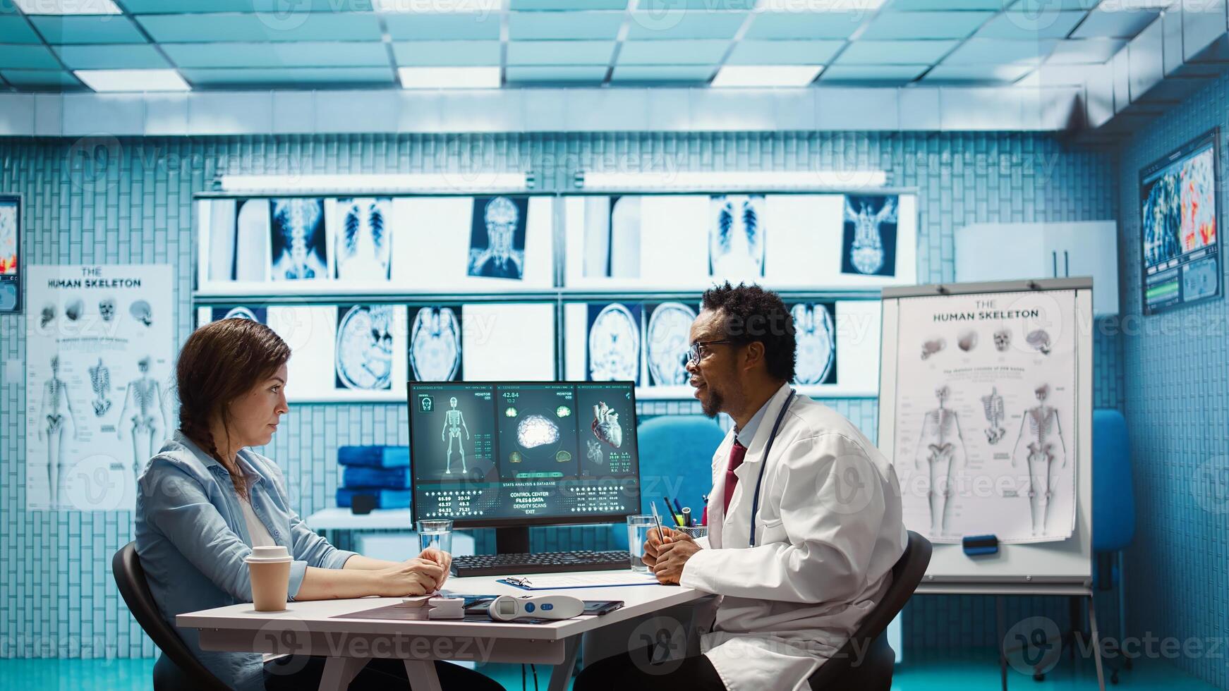 General practitioner giving the right diagnosis to woman patient, attending a checkup consultation in medical cabinet. Doctor explaining x ray imaging and scan results, care management. Camera B. photo