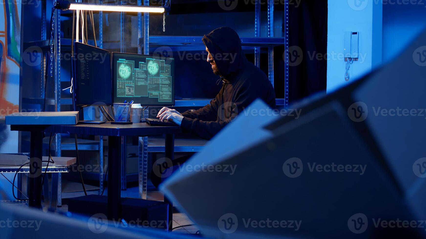Professional spy in underground location hired by government to do international espionage warfare on other countries, using high tech computer systems to infiltrate past protection firewalls photo
