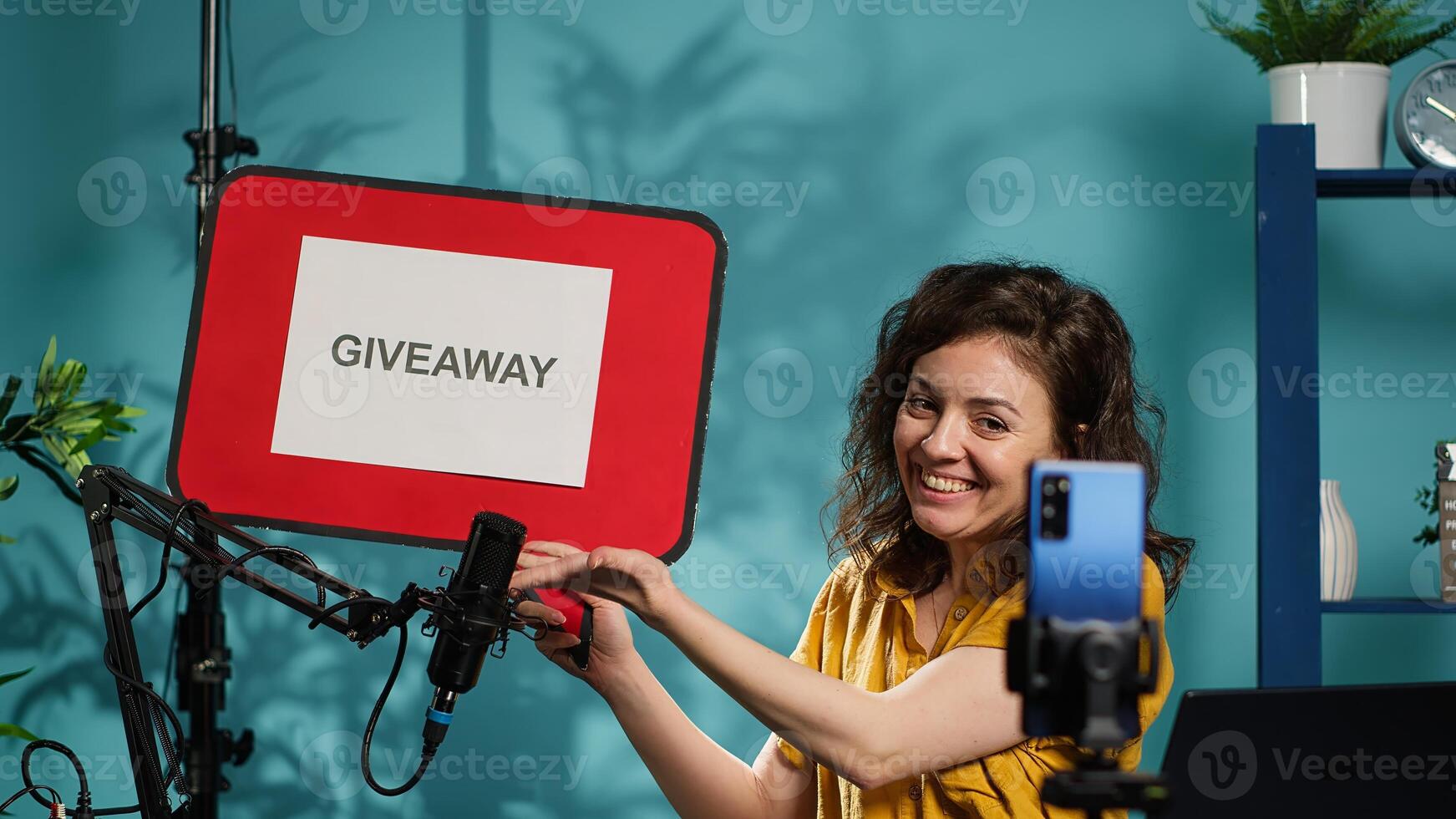 Entertainer holding empty copy space sign, excited to do giveaway for social media followers, offering rewards. Media star happy to gift viewers prizes, using cardboard bubble speech cutout, camera A photo