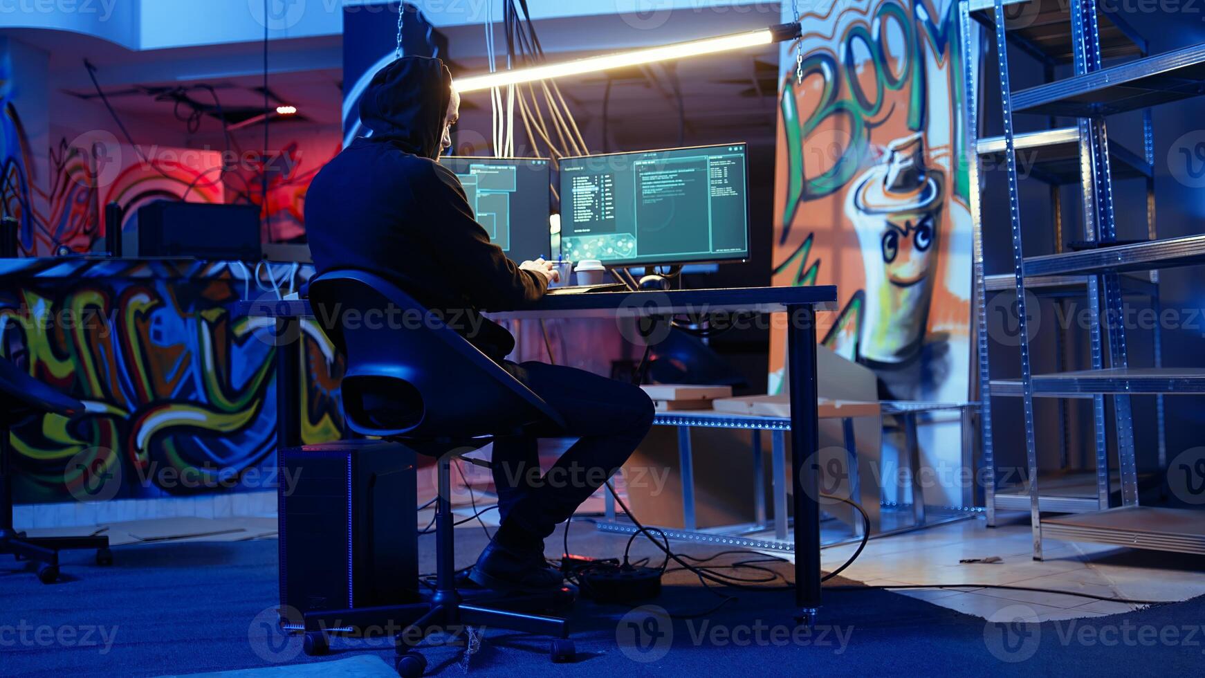 Security hacker exploring methods of breaching defenses and exploiting weaknesses in computer networks. Malicious programmer in basement getting past firewalls, handheld camera shot photo