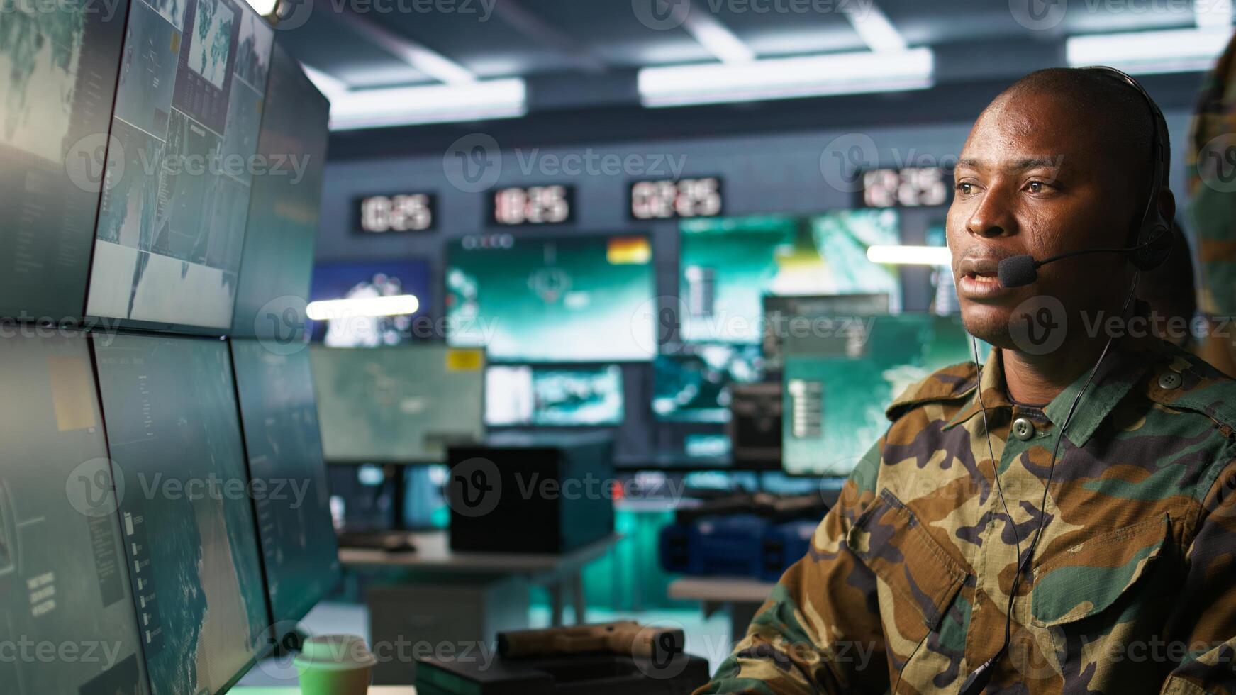 Army telecommunication systems operator using radio gear, providing combat support, doing patriotic duty. African american military dispatcher managing communications networks, camera B photo