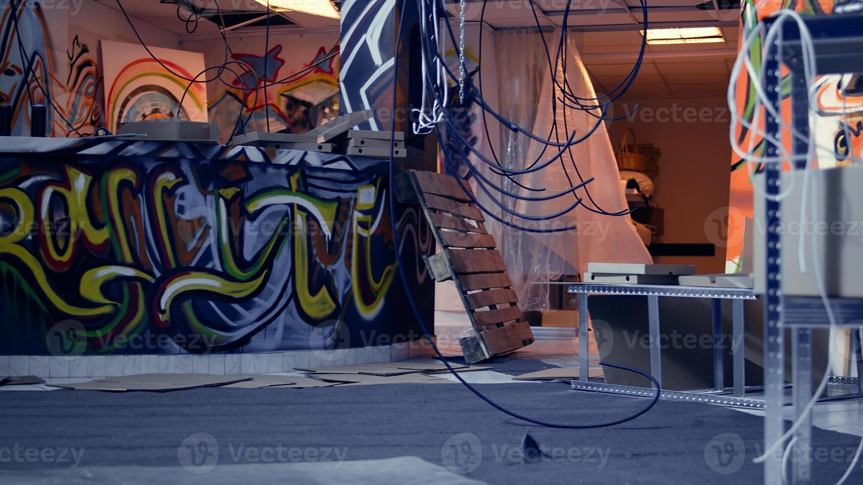 Empty derelict building with creative graffiti street art on walls, concept of alternative lifestyle. Dirty wrecked base of operations used by criminals to commit illegal activities, panning shot photo