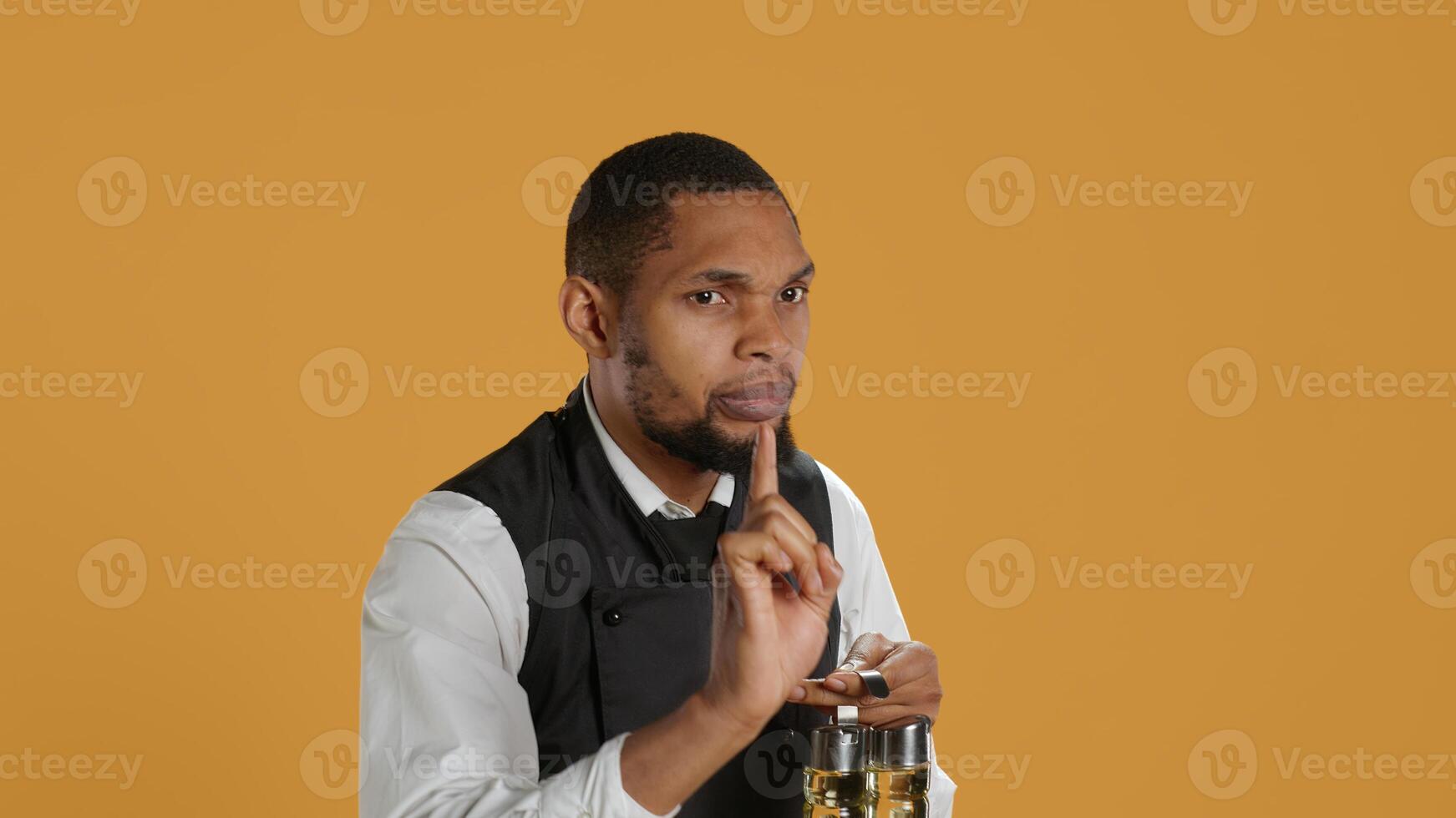 Professional waiter asking clients to wait a bit before serving them, working in a very busy restaurant. Employee trying to serve customers faster, showing professionalism in catering. Camera A. photo