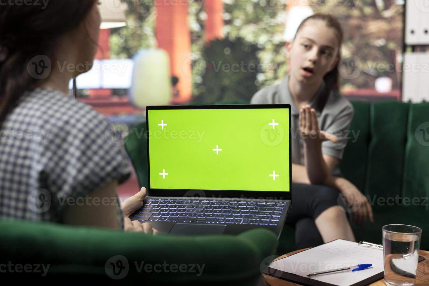 Teenager undergoing therapy for depression next to isolated chroma key screen, asking advice to boost self esteem. Psychologist expert guiding her to overcome her internal frustration. photo