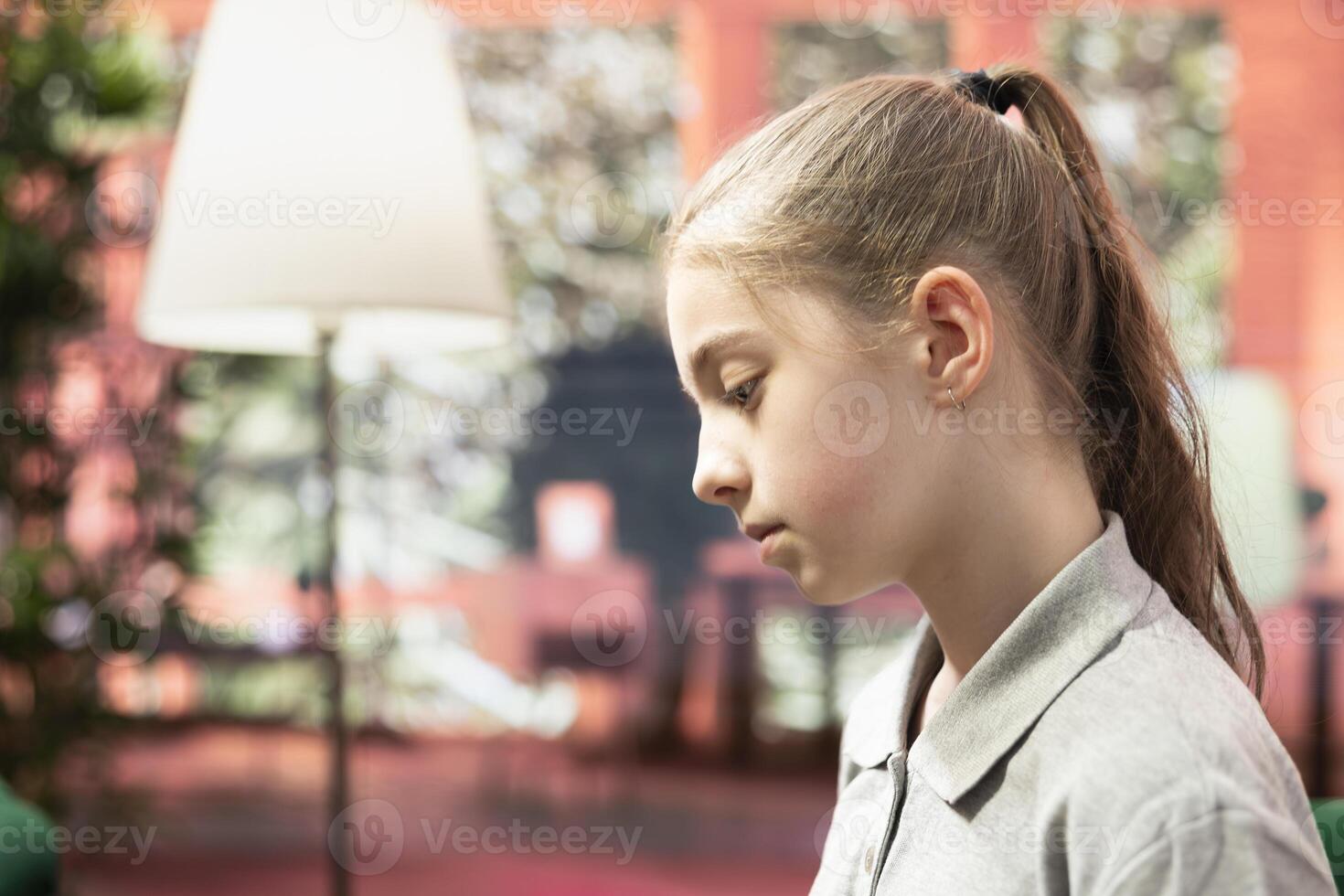 Depressed teenage girl suffering from bipolar disorder and intrusive thoughts, trying to overcome anxiety and social issues at therapy session. Counseling for the young generation. Close up. photo