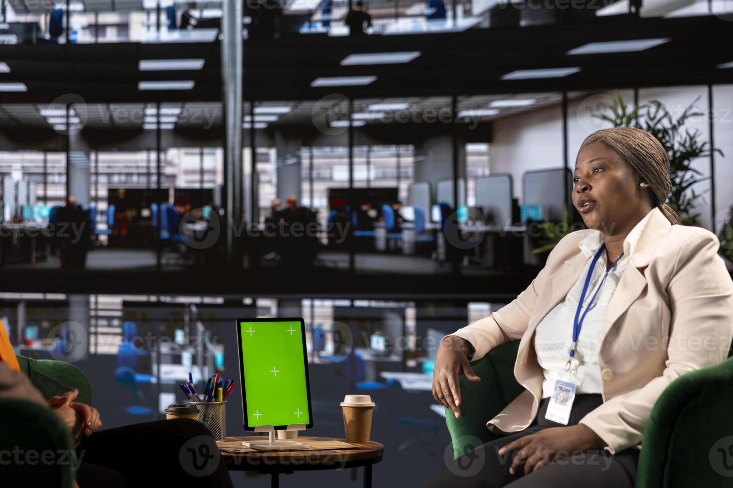 Multiethnic businesswomen working next to isolated green screen, solving their daily tasks for the project to achieve enterprise objectives and work on global development. Corporate feminism. photo