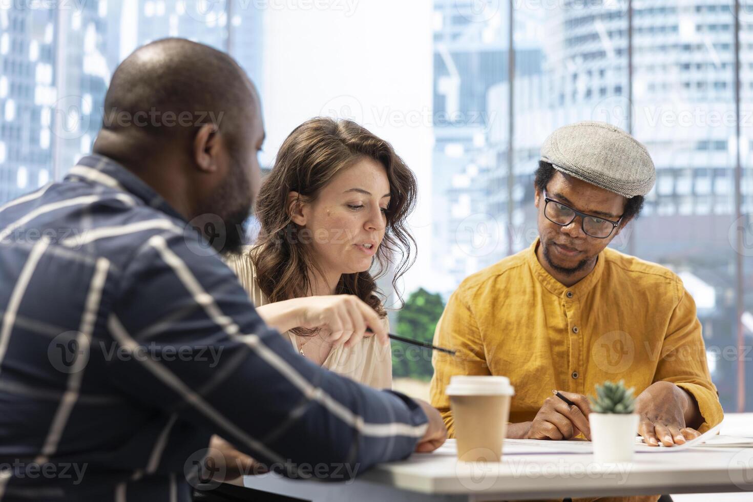 Businesswoman sharing her vision and discussing about concerns regarding the lease on high class office space. Collaborating with real estate brokers experts to strategize investment. photo