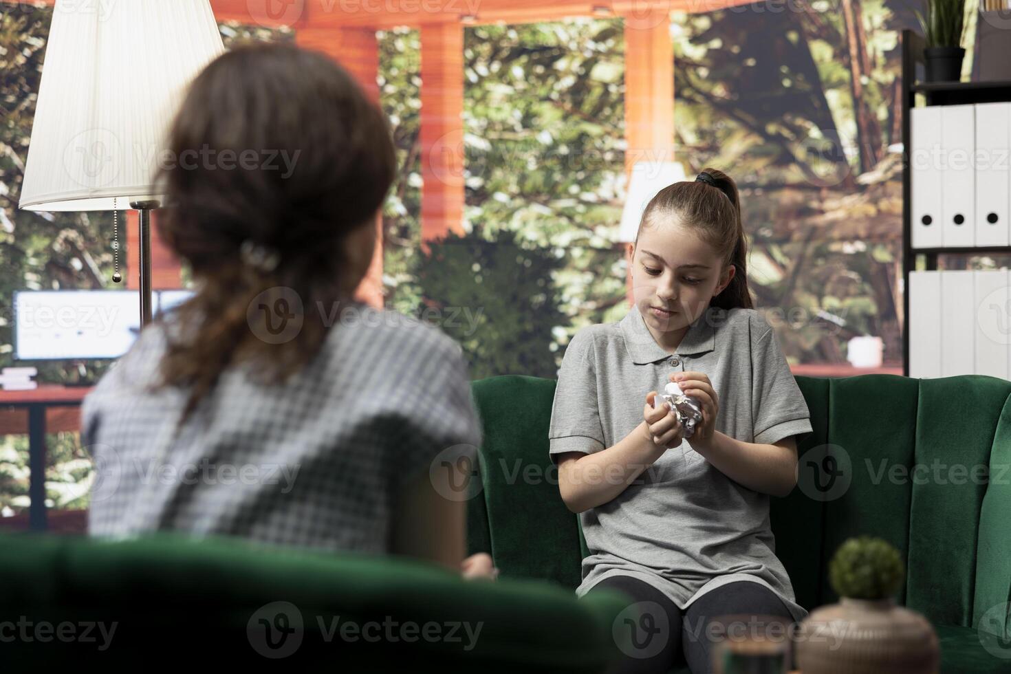Rebellious teenager vents frustration at the psychotherapist, expressing unhappiness, trauma and emotional challenges in the process of anger management and behavioral therapy. Mood swings. photo