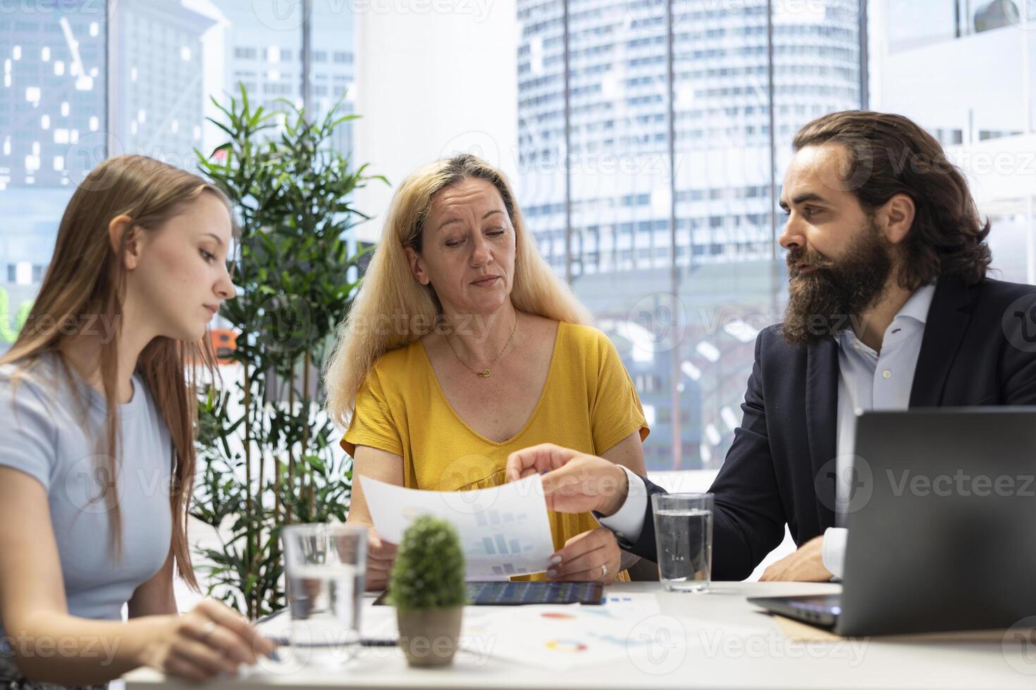 Financial advisor helping mother and daughter build and maintain healthy budget, avoiding overspending. Agent in office building emergency fund for clients to cover going over credit limit photo