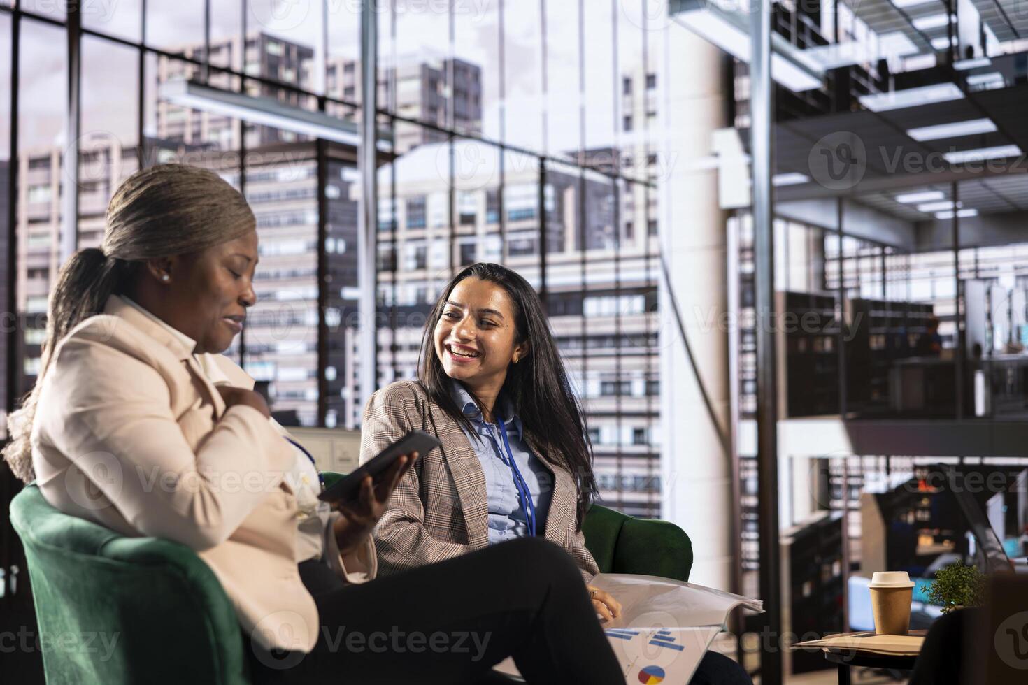 Multicultural group of businesswomen in a high powered meeting, promoting gender equality and female authority in a work environment. Leaders in a male dominated industry, enlightened world photo