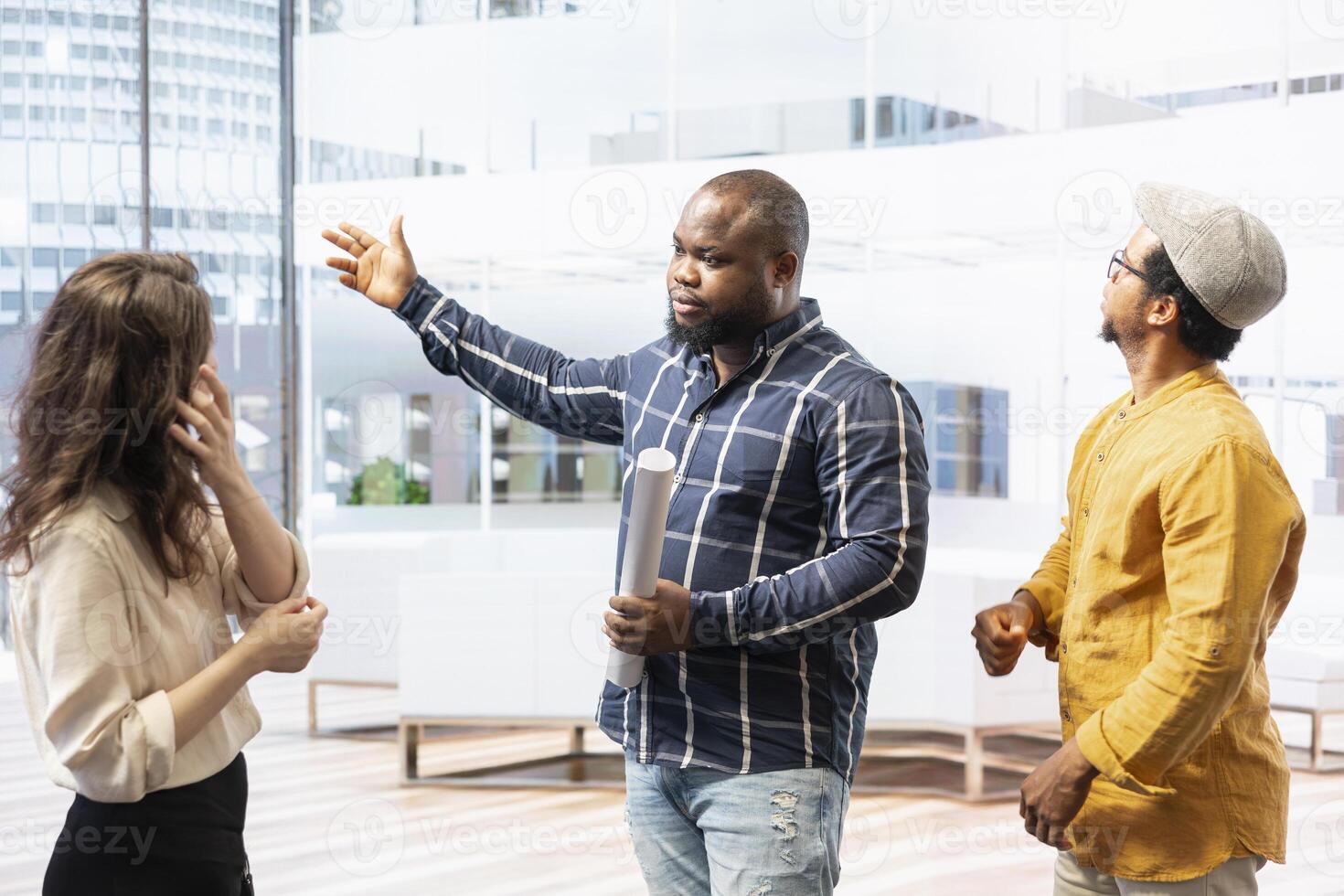 Entrepreneurial team and realtor expert evaluating office space layout during a tour, focusing on blueprints and strategic planning for leasing property. Business investment plans. photo