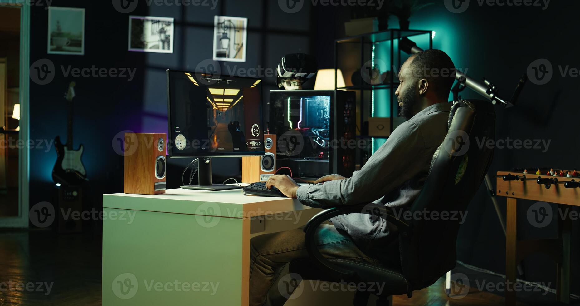 Man in neon lit apartment playing immersive games on gaming PC at computer desk, handheld camera shot. Gamer competing against enemies in internet multiplayer shooter, camera B photo
