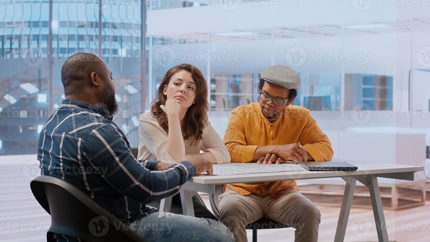 Entrepreneur meeting with a real estate broker on an office tour, guiding the client around the high class workspace and presenting architectural plans and blueprints. Business investment. Camera B. photo