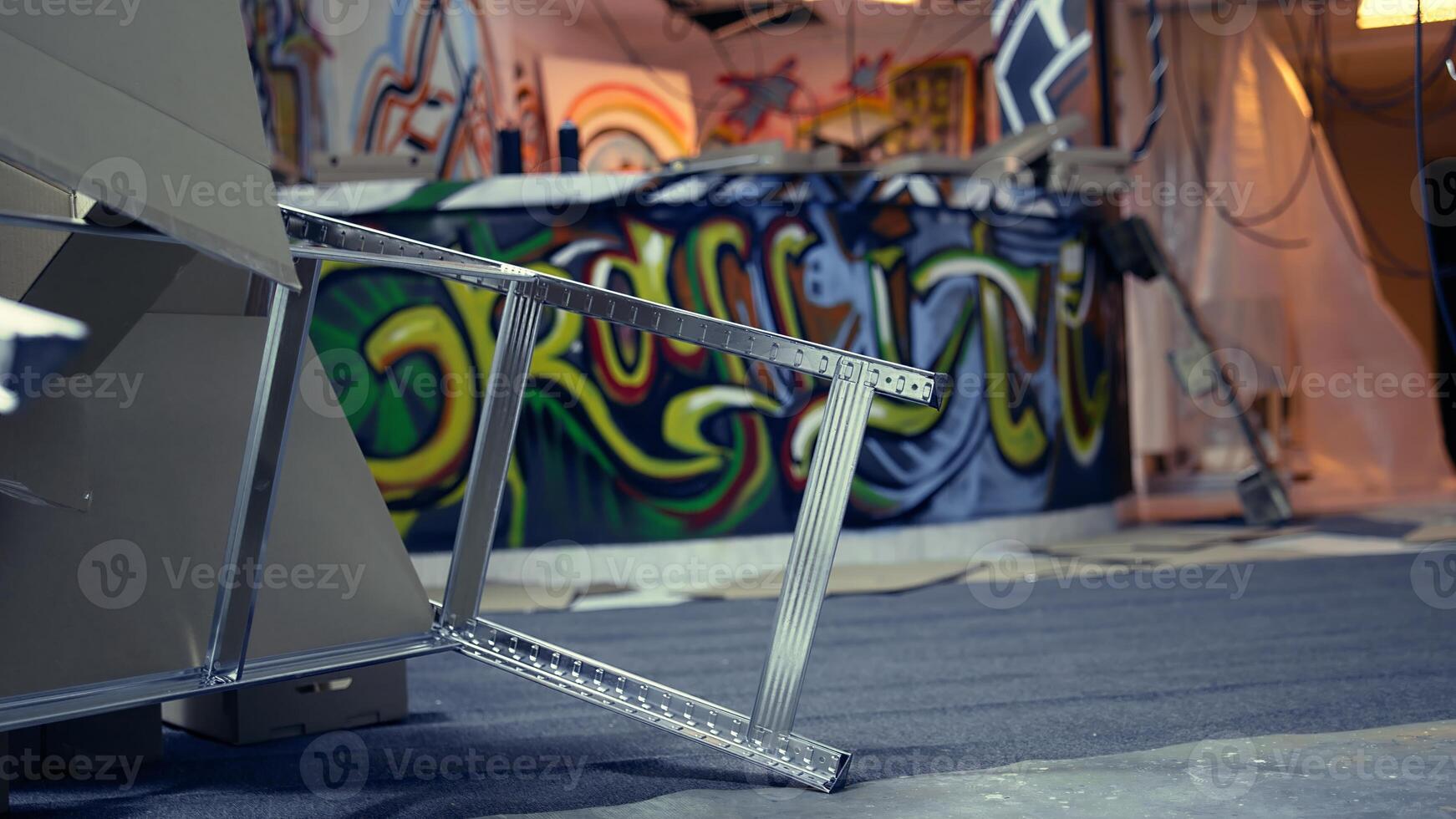 Empty basement with damaged objects and graffiti paint, concept of urban culture. Criminal hideout used by gang members to commit illegal activities, handheld camera shot photo