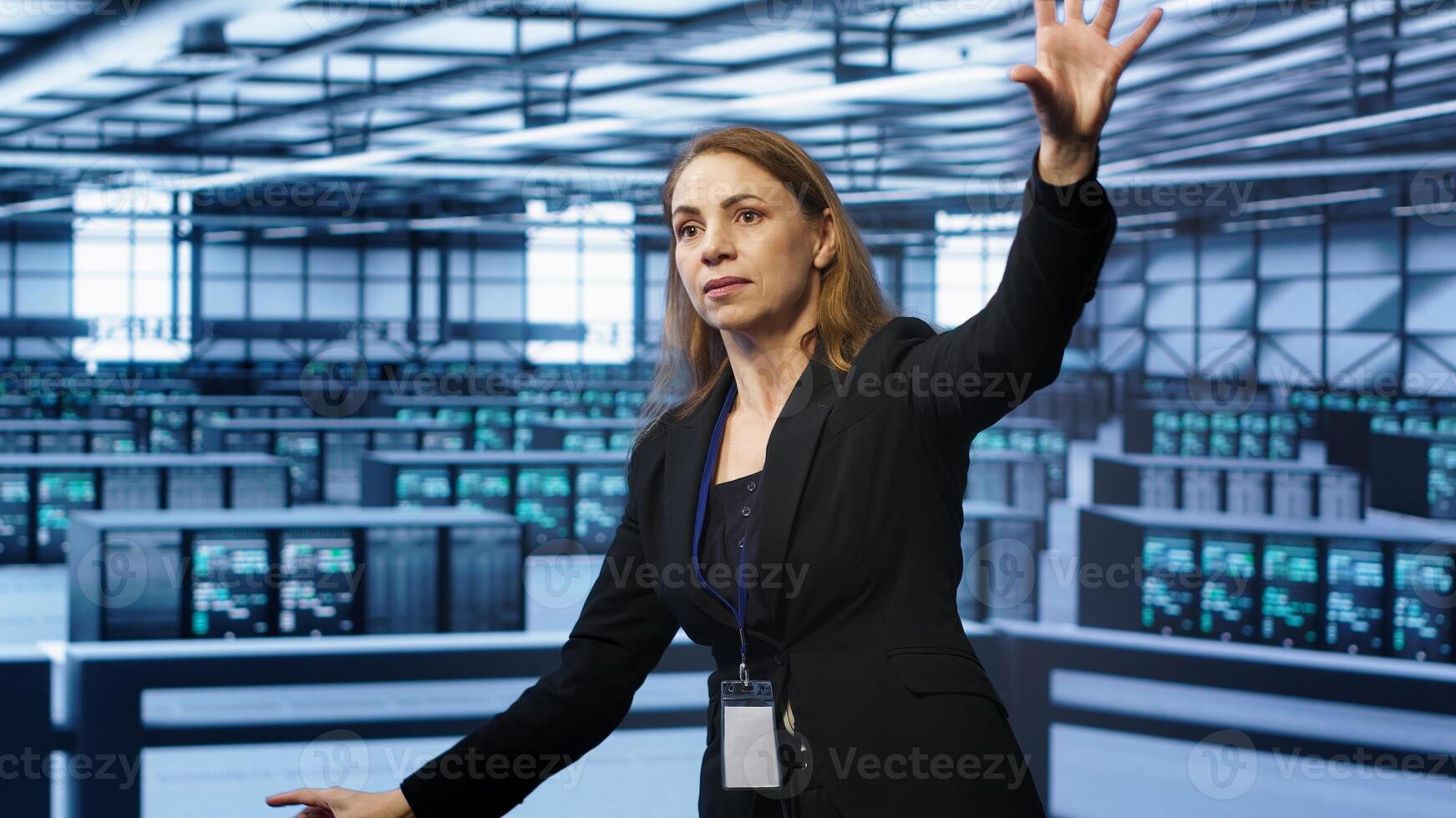 Software developer looking at holograms in data center, monitoring infrastructure. Woman in server room interacting with high tech augmented reality AI visualization, camera A photo
