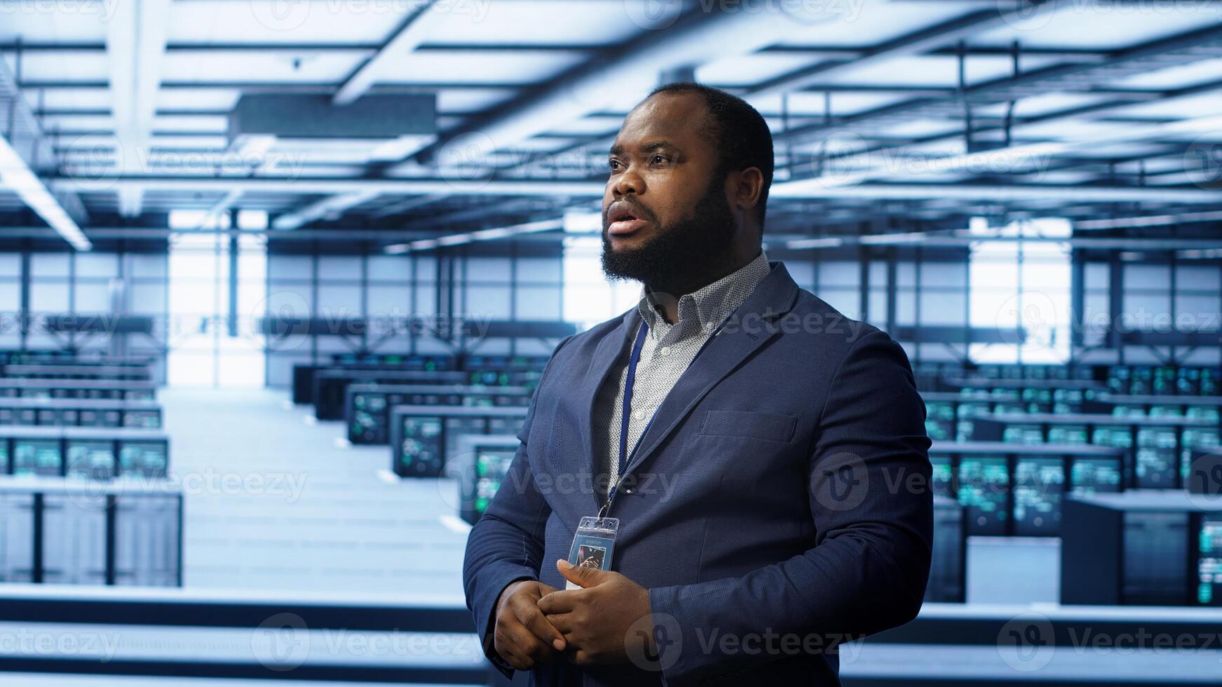 System administrator looking at holograms in data center, monitoring equipment. Employee in server farm interacting with futuristic augmented reality AI visualization, camera A photo