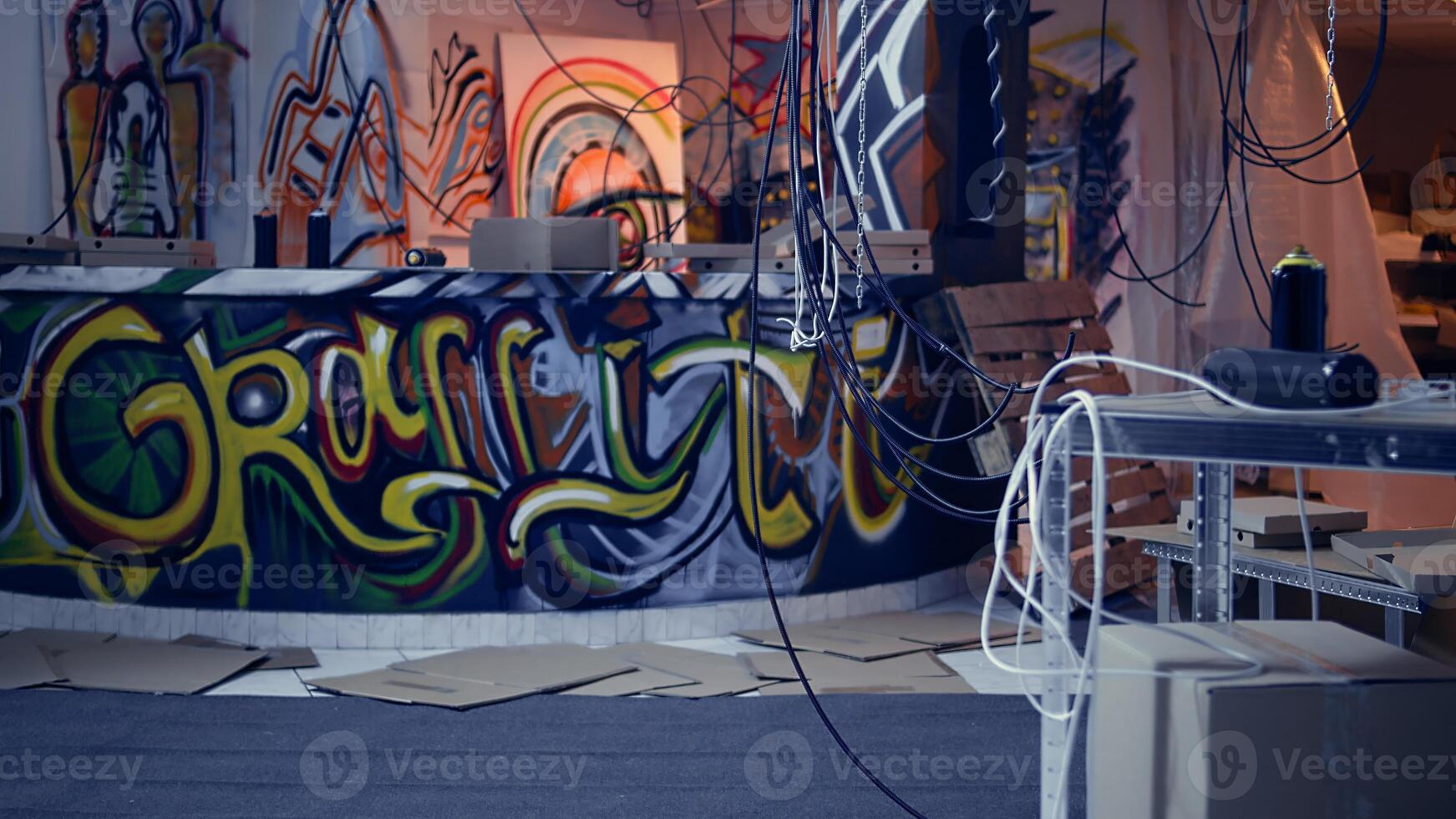 Desolate headquarters used by gang members with graffiti drawings sprayed on walls. Rubble in ghetto hideout after criminals rushed to evacuate place, dolly in camera shot photo